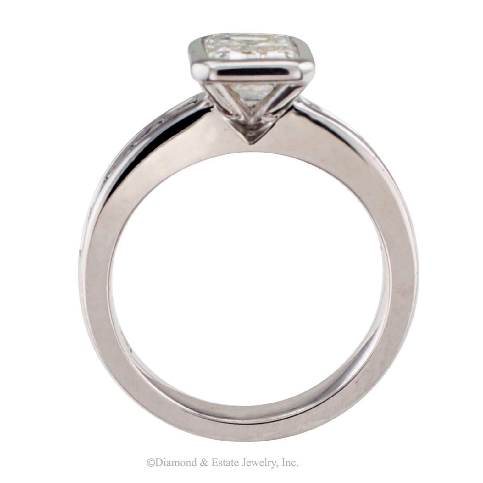 1.08 Carats Emerald Cut Diamond Gold Engagement Ring

Modernist  style 1.08 carats emerald cut diamond G - H color mounted in 18-karat white gold.  A very different take on presenting a beautiful diamond, bezel-set on prongs so that plenty of light