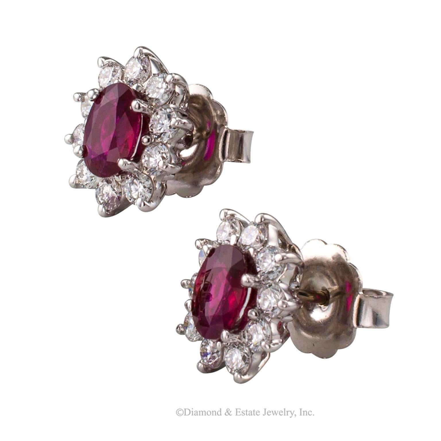 Ruby Diamond White Gold Cluster Earrings

Ruby and diamond cluster earrings mounted in 18-karat white gold circa 1990.  Pretty ruby and diamond  flowers for your ears featuring a pair of clear and bright red, oval rubies together weighing