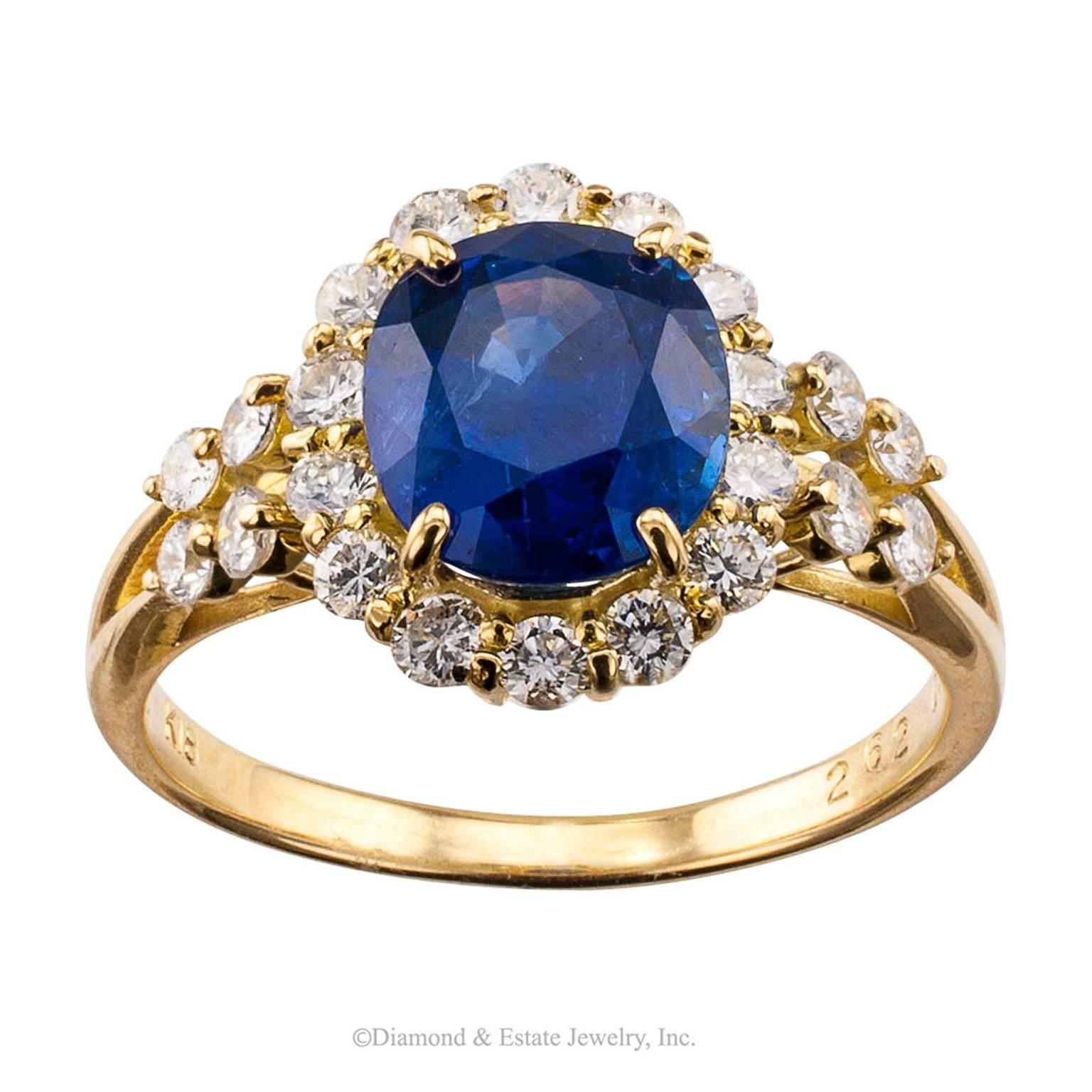 Sapphire Diamond Gold Halo Ring

2.62 carats oval sapphire halo cluster ring bordered by diamonds totaling 0.58 carat mounted in 18-karat yellow gold circa 1990. The weights of the stones are engraved inside the shank of this lovely sapphire and