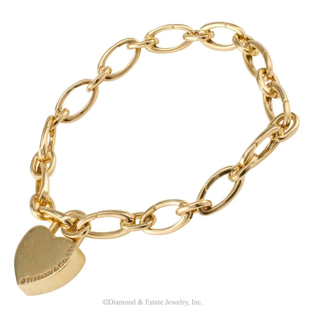 Tiffany Mom Charm And Tiffany Gold Charm Bracelet

Tiffany "Mom" charm with Tiffany gold link charm bracelet circa 1990.  Connected by solid links alternating with longer hinged oval links to facilitate connecting or re-configuring the