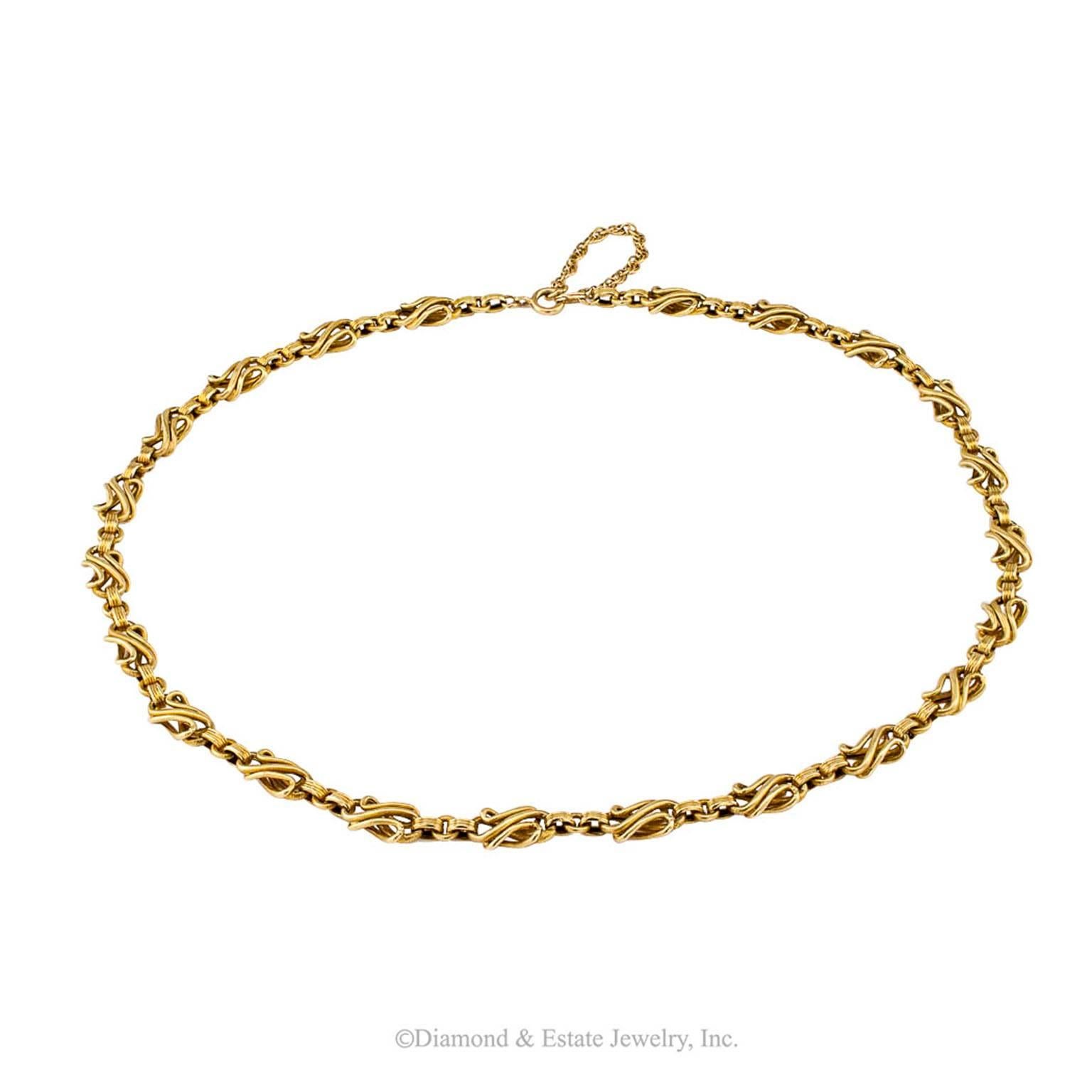 1900s Handmade Gold Chain Necklace

1900s handmade gold chain necklace.  The 14-karat yellow gold design is based on a composition of fluid shapes and strong geometric lines continuously alternating with each other.  Ideal for wearing by itself or