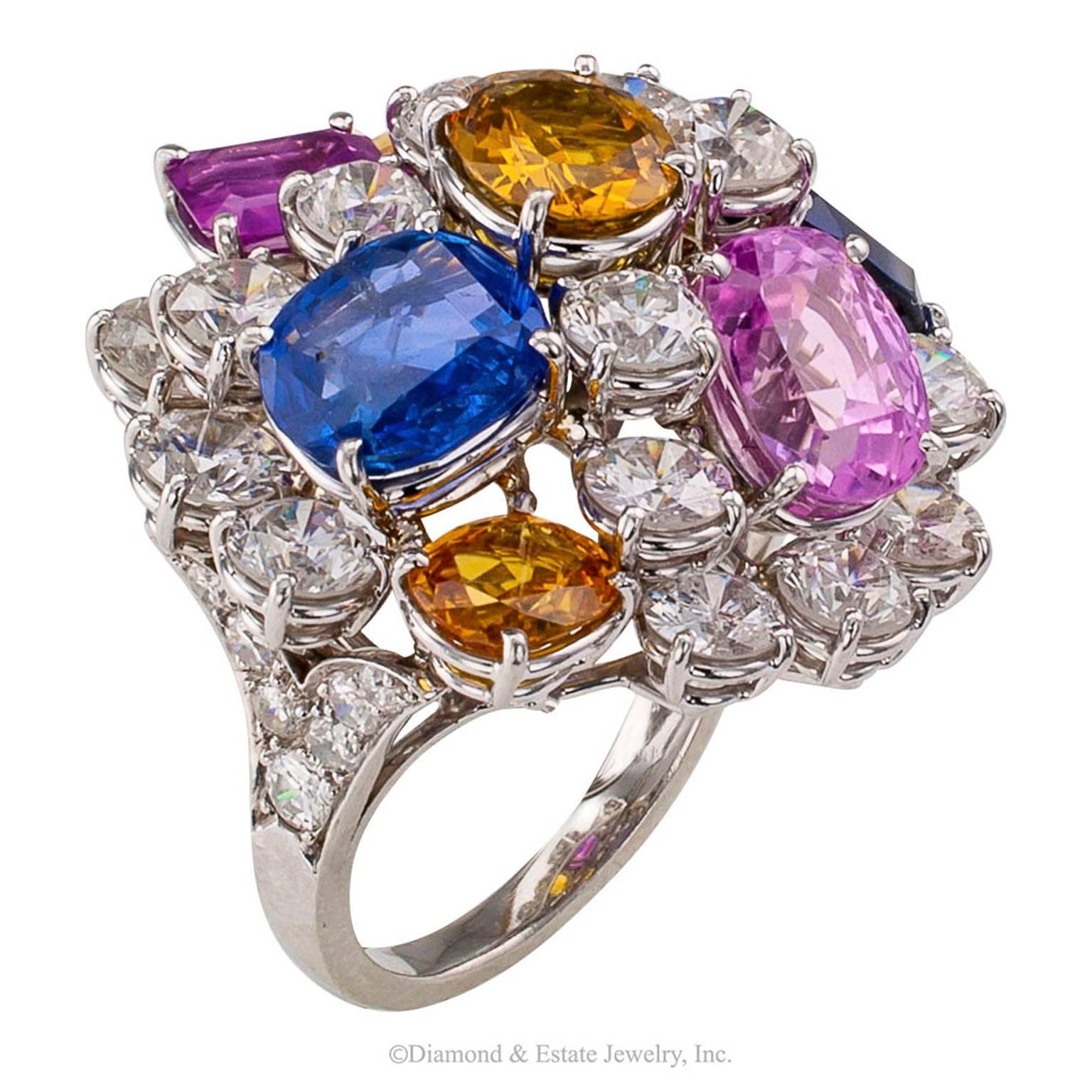 Ruser Diamond Sapphire Platinum Cocktail Ring

1950s Ruser multi colored sapphire and diamond cocktail ring mounted in platinum.  It is grand, colossal, a mountain of large diamonds with boulders of blue, pink and yellow sapphires.  It is said that