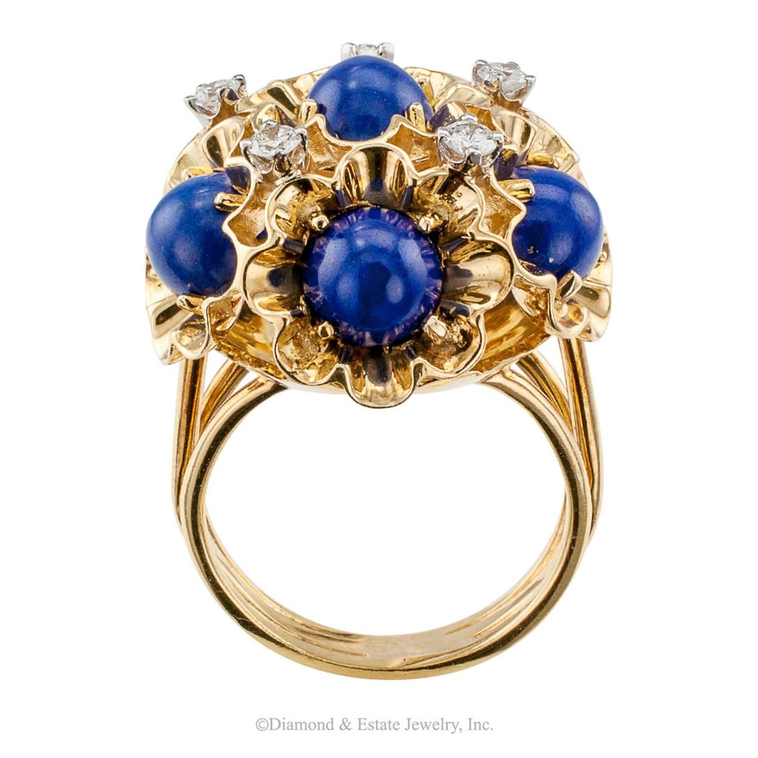Dankner Lapis Lazuli Diamond Domed Gold Ring

Dankner lapis lazuli and diamond domed cluster ring mounted in 18-karat yellow gold circa 1970.  Designed as a uniform bouquet formed by six individual flowers with five evenly spaced diamonds in