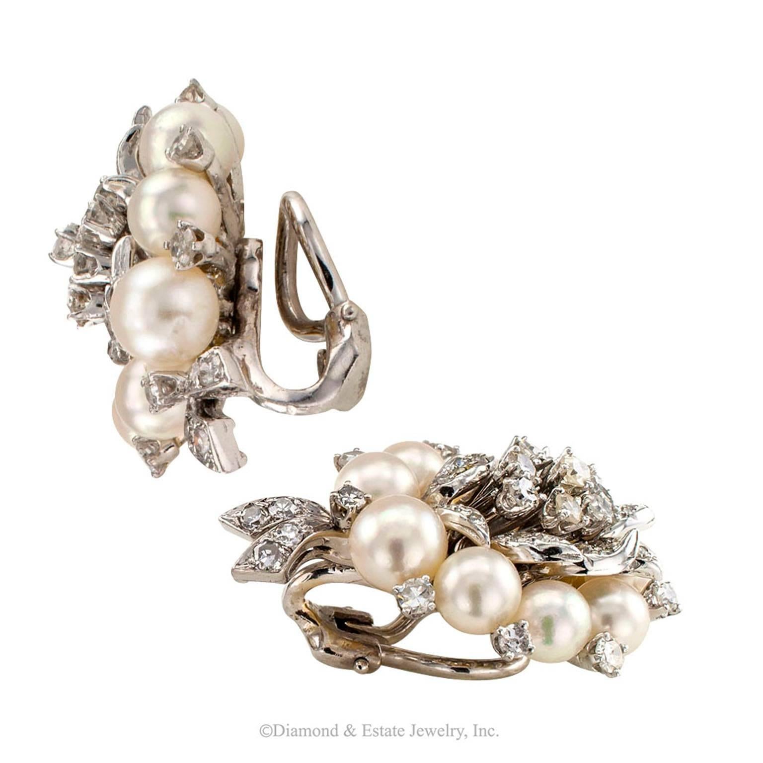 1950s Cultured Pearl Diamond Gold Ear Clips

Mid-century cultured pearl and 2.75 carats diamonds and gold cluster ear clips circa 1950.  The 14-karat white gold designs are a perfect embodiment of the elegant and utterly feminine style of the