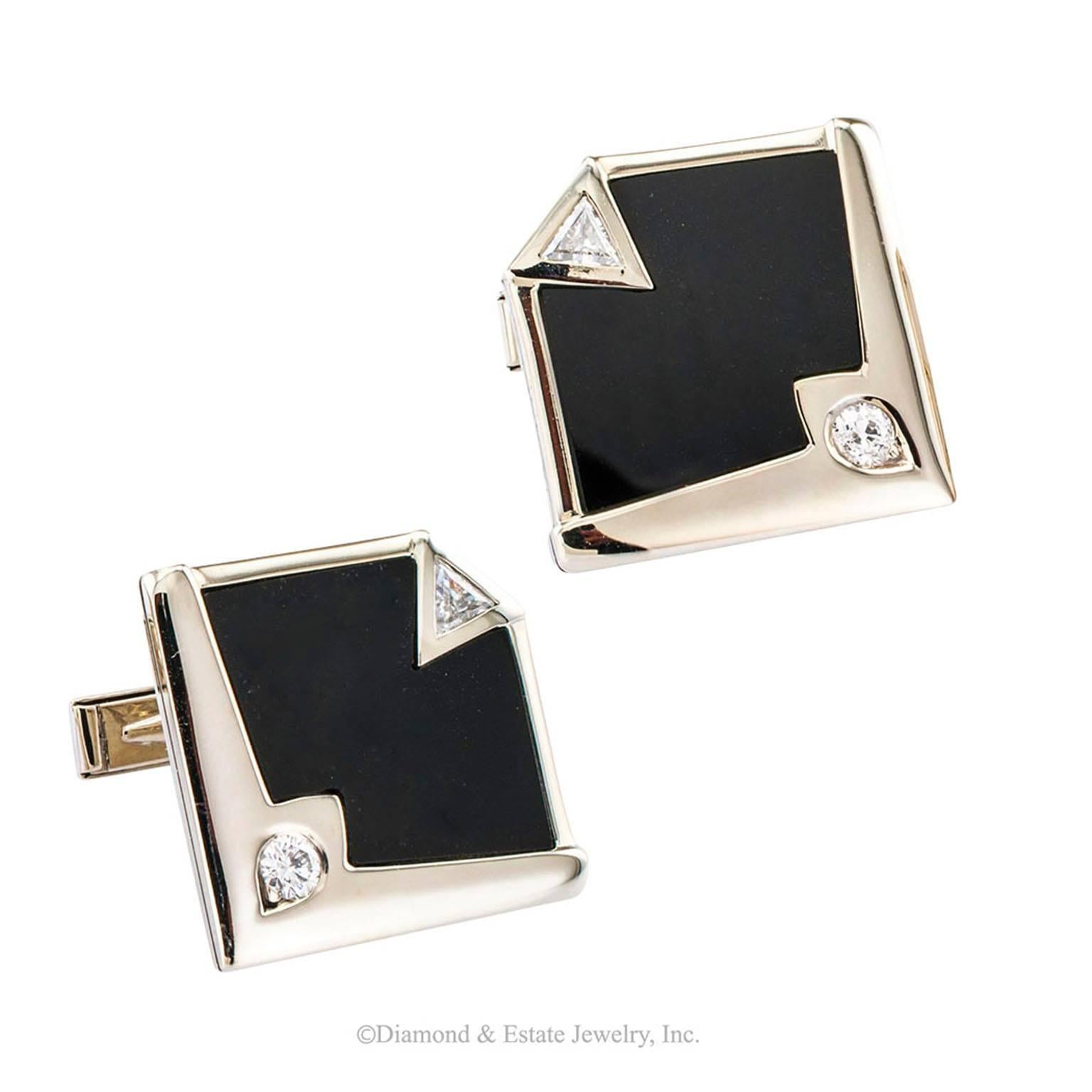 Modernist Onyx Diamond White Gold Cuff Links

Onyx and diamond 14 karat white gold cuff links.  The avant garde designs take full advantage of the aesthetic derived from harmonious balance between sharp angled lines and mirror-polished surfaces. 