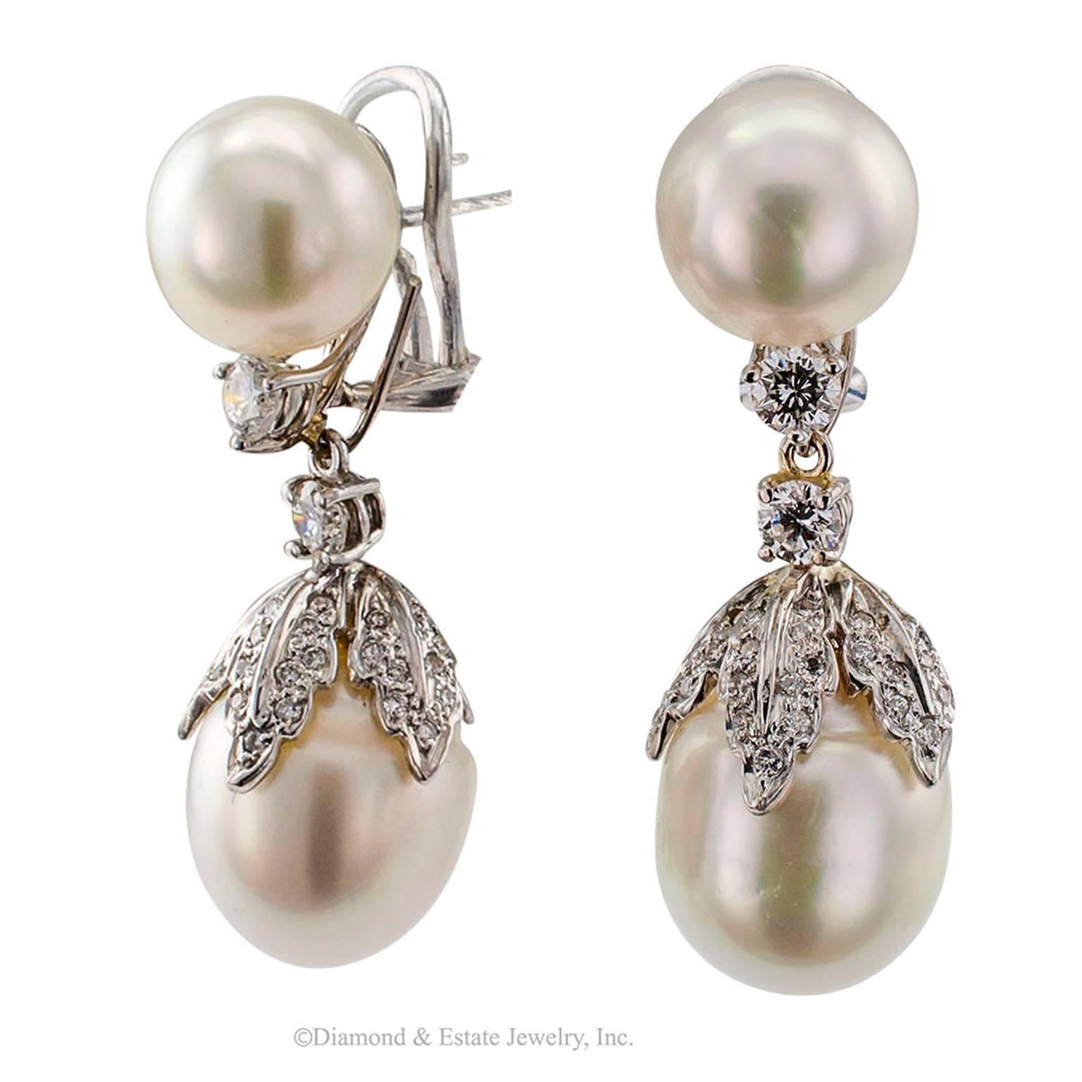 Day Into Night South Sea Pearl Diamond Gold Earrings

Day-into-night South Sea pearl and diamond drop earrings mounted in 18-karat white gold.  Comprising a pair of South Sea pearls measuring 11 mm, each under-mounted with a small round brilliant