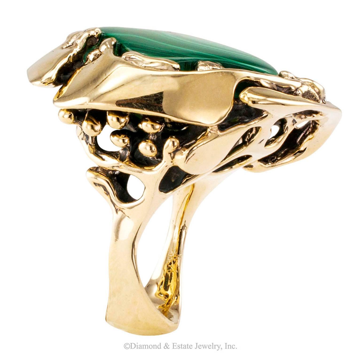 1960s Modernist Malachite Bulls Eye Abstract Gold Ring

1960s Modernist malachite free-form bull's eye set in an abstract gold ring.  The design centers upon a free-form malachite cabochon characterized by a very well defined bull's eye, within a