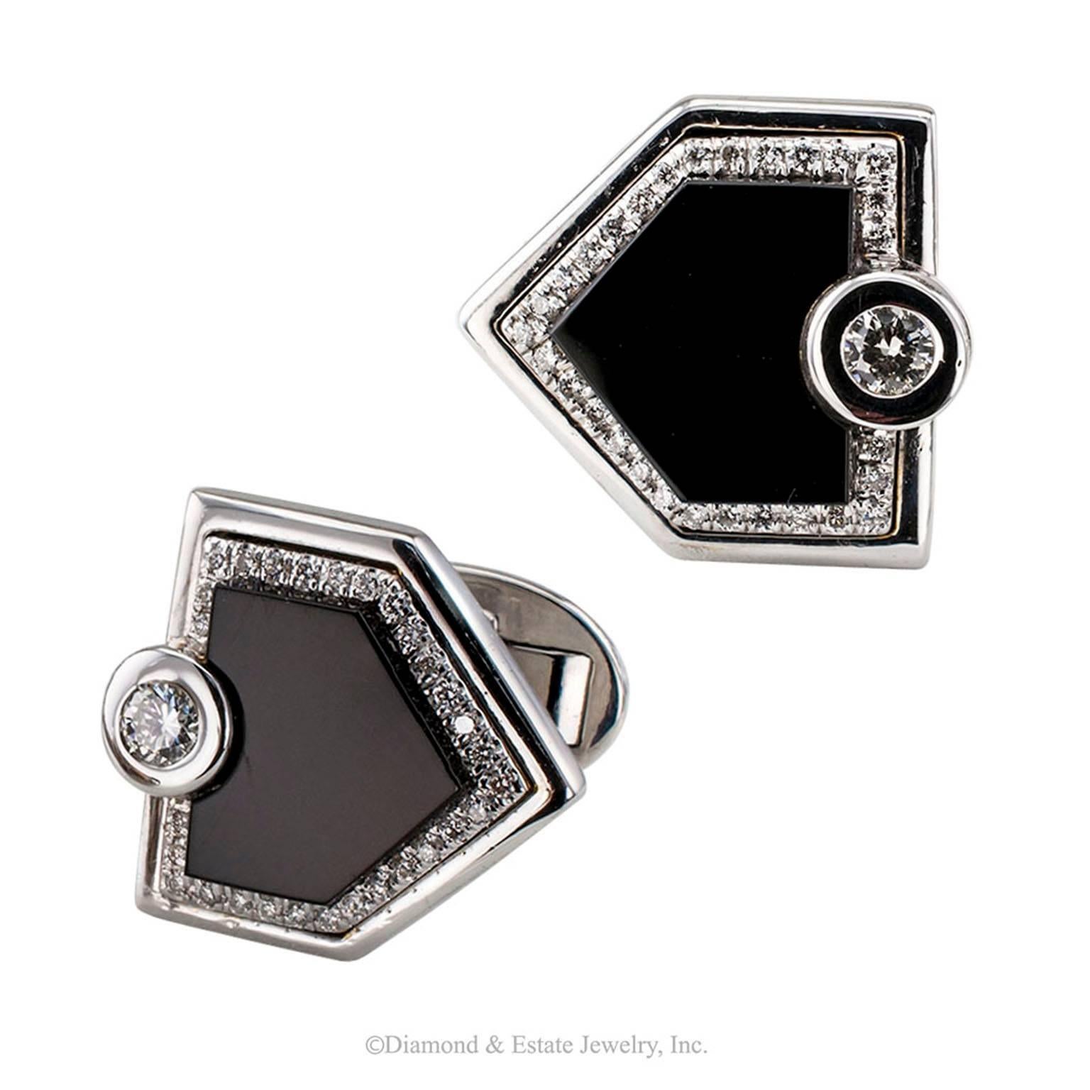 Onyx Chevron Diamond Gold Cuff Links

Black onyx chevron and 0.50 carat diamonds gold estate cuff links.  Centering a black onyx chevron motif set sideways, within a conforming border of round brilliant-cut diamonds completed by a larger, bezel-set,
