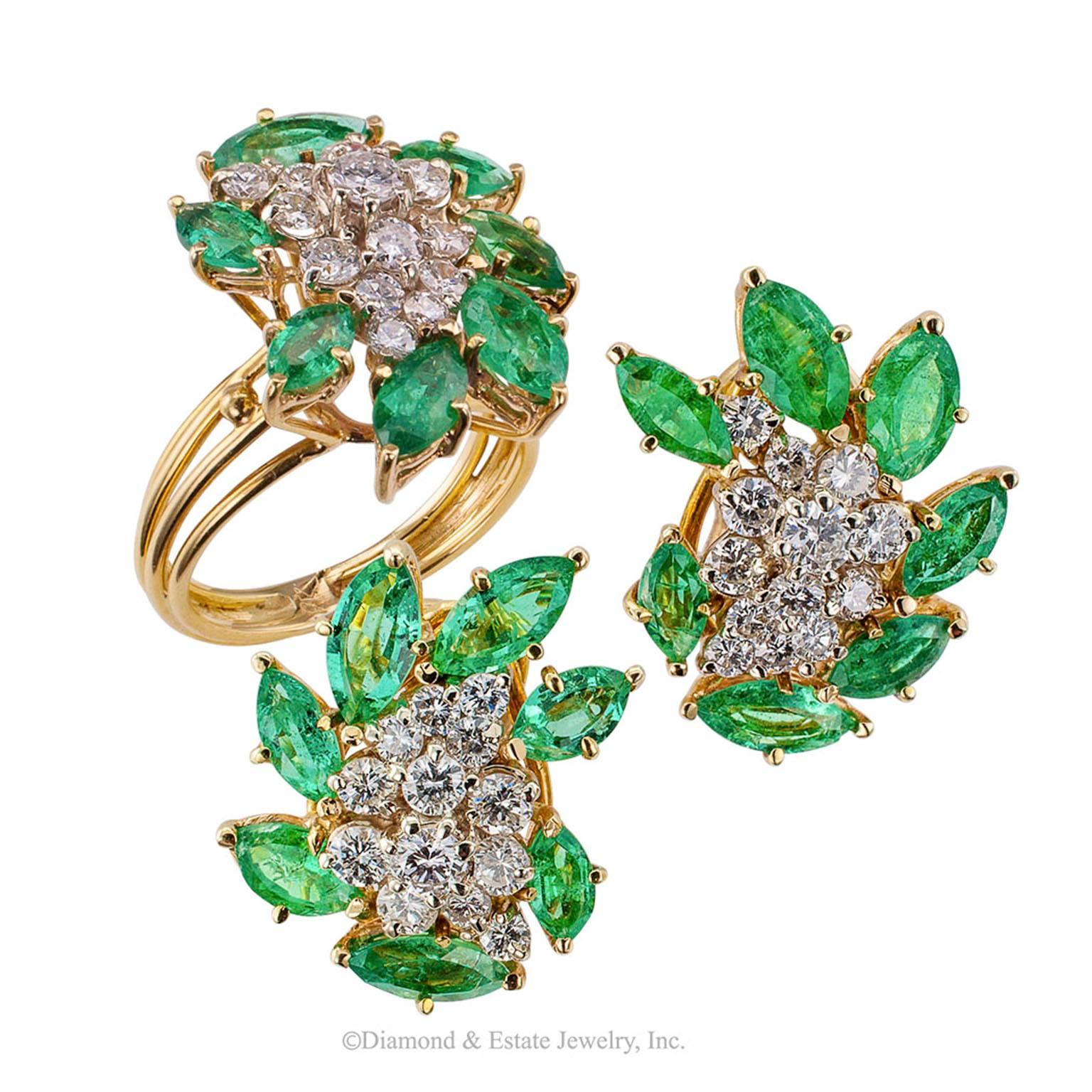1970s Emerald Diamond Gold Cocktail Ring

1970s emerald and diamond cocktail gold ring.  Designed as a cascading cluster of round brilliant-cut diamonds weighing approximately 0.75 carat, approximately H color and SI clarity, within a radiating