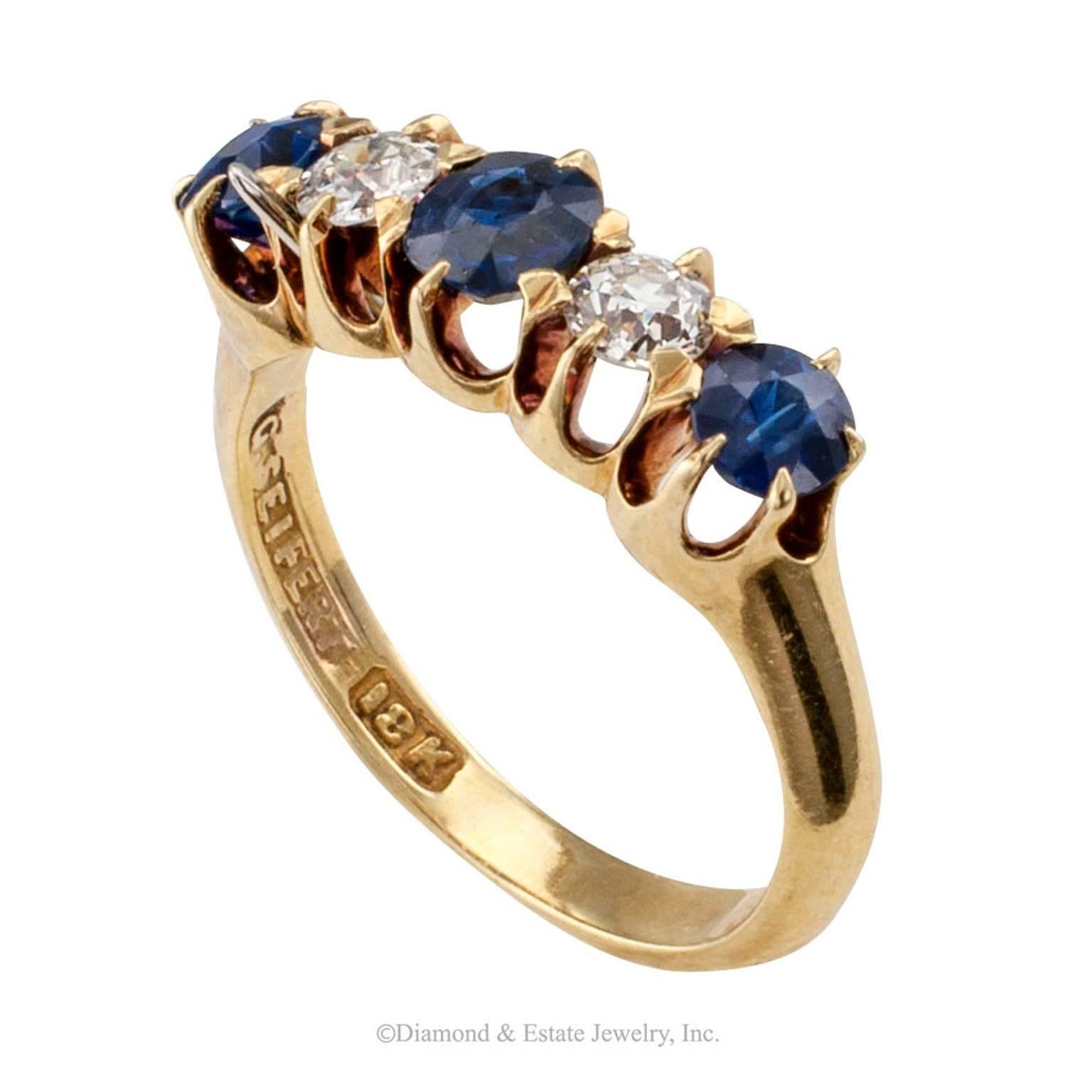 G. Seifert Victorian Diamond Sapphire Five-stone Gold Ring Band

G. Seifert Victorian sapphire and diamond five-stone 18-karat gold ring band, circa 1890s.  Featuring a pair of old European-cut diamonds totaling approximately 0.25 carat,