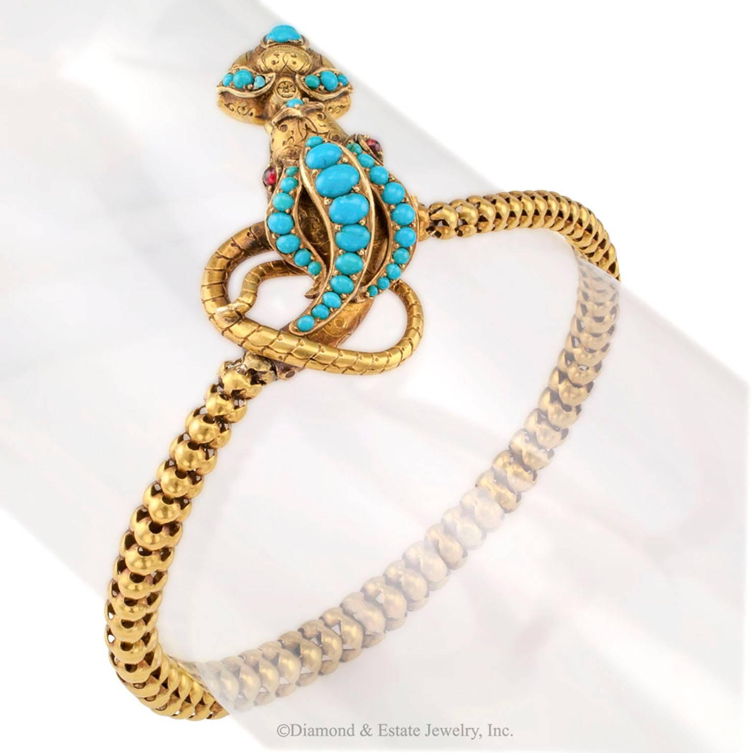 Victorian Cobra Snake Gold Bracelet With Turquoise And Garnets

Victorian gold cobra snake bracelet and locket set with turquoise and garnets circa 1880.  Enchanting as a dancing cobra, its head decorated by three courses of graduating turquoise