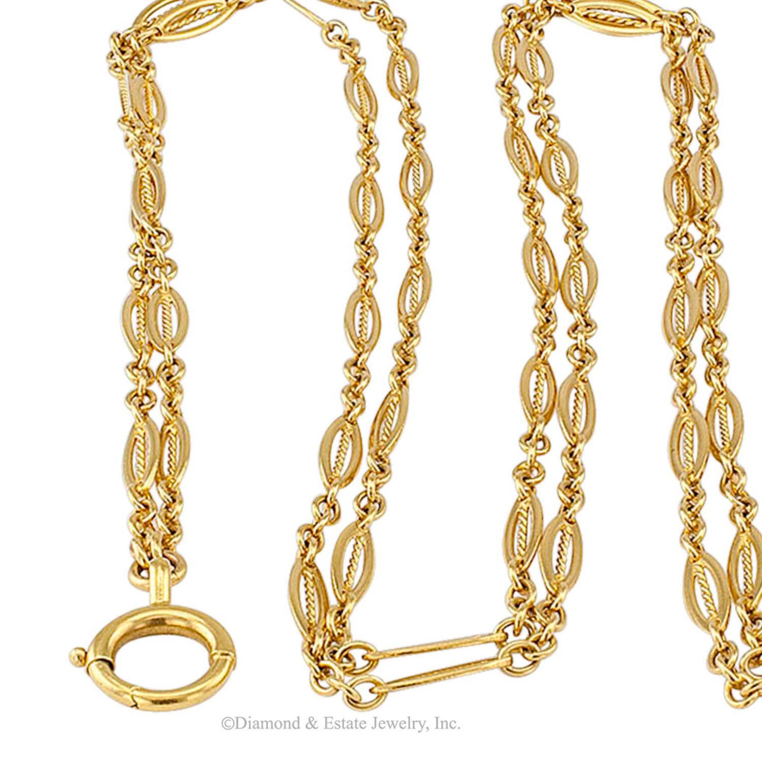 French Antique Long Chain Gold Necklace

French 1900s long chain necklace in 18-karat gold.  Hand crafted, flat and open, navette-shaped links filled with a twisted wire motif on a continuous loop 60" long, fitted with a side jump ring to