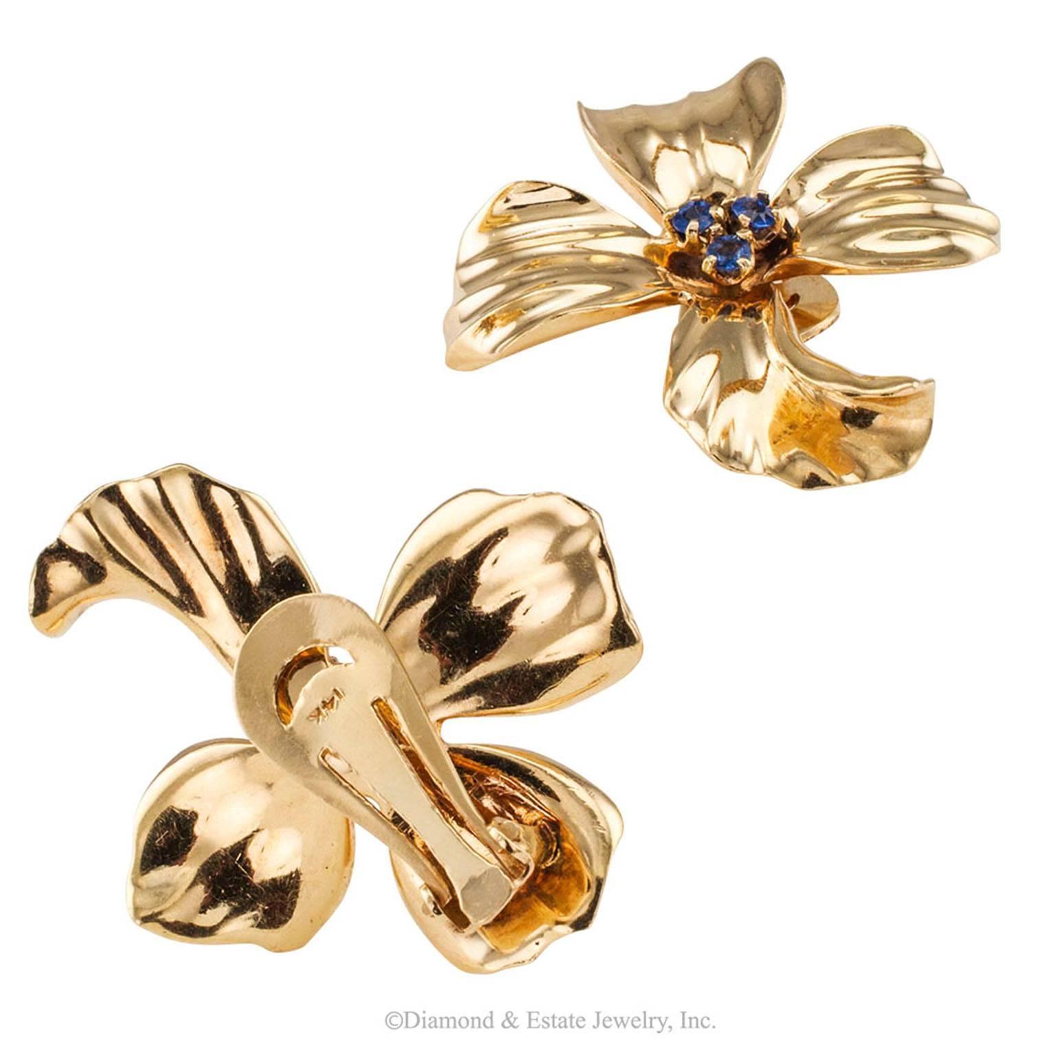 1950s Dogwood Flower Sapphire Gold Ear Clips

Dogwood flower ear clips set with sapphires crafted in 14-karat gold circa 1950.  Left and right matching designs comprising  a  pair of dogwood flowers each centering three prong-set, round blue