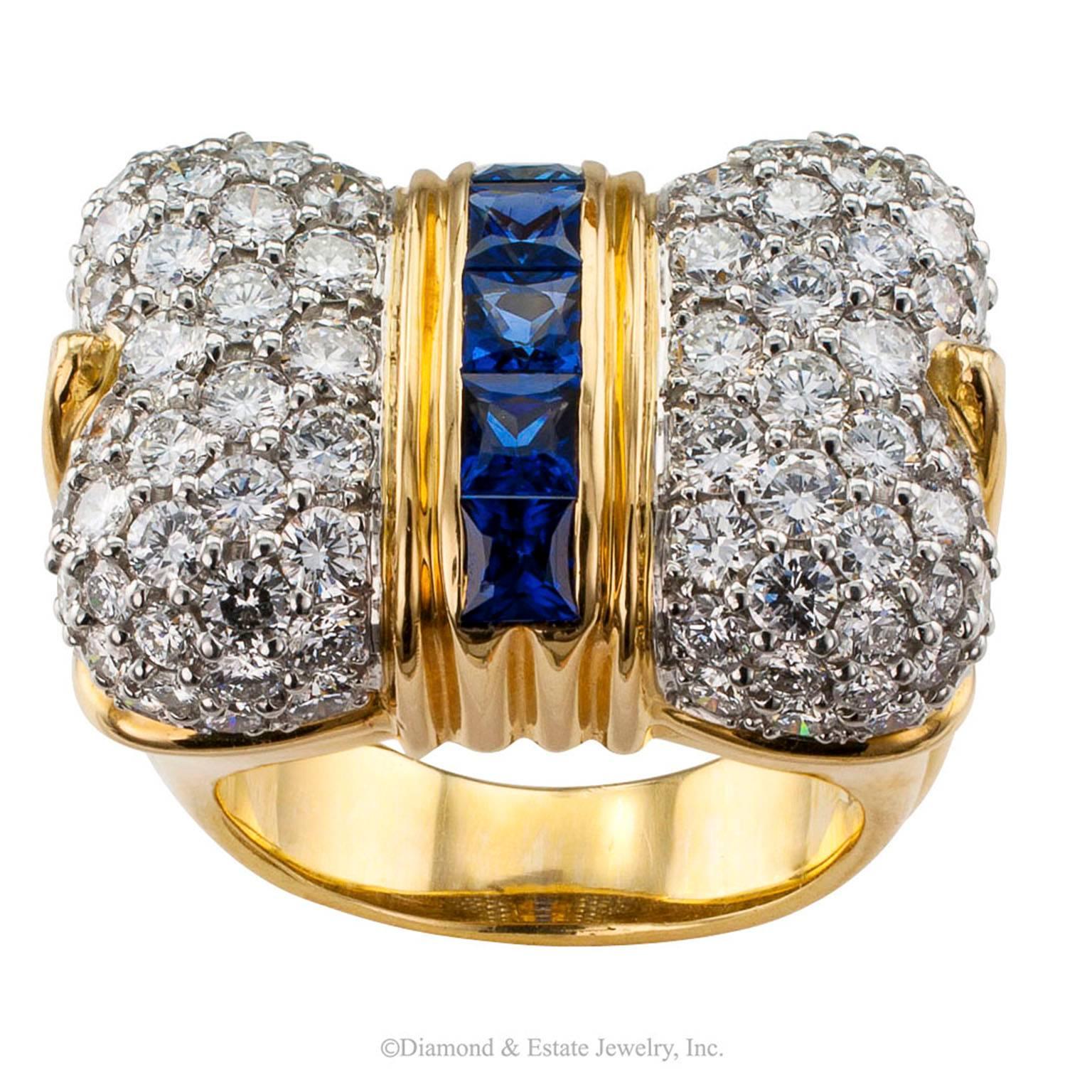 1980s Bow Ring Diamond Sapphire Gold Platinum

1980s bow ring set with diamonds and sapphires mounted in 18-karat gold and platinum.  Slightly bombe and pave set with ninety round brilliant-cut diamonds totaling approximately 3.00