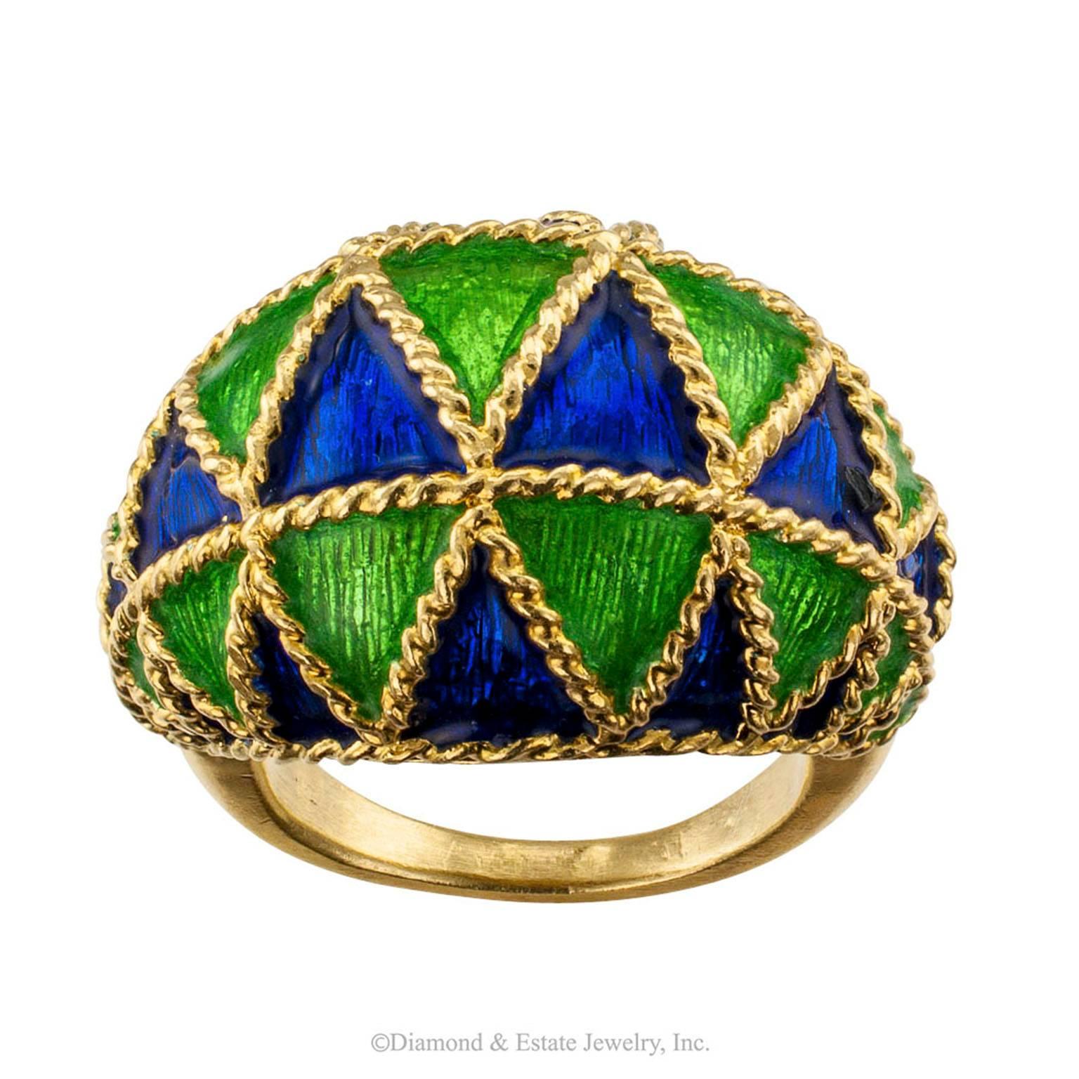 1970s Domed Ring Blue Green Enamel Gold

Domed ring 1970s blue and green enamel crafted in 18-karat gold.  Attractive rows of alternating blue and green enamel triangles bordered with corded gold motifs, graduated on a rising arch across the finger,