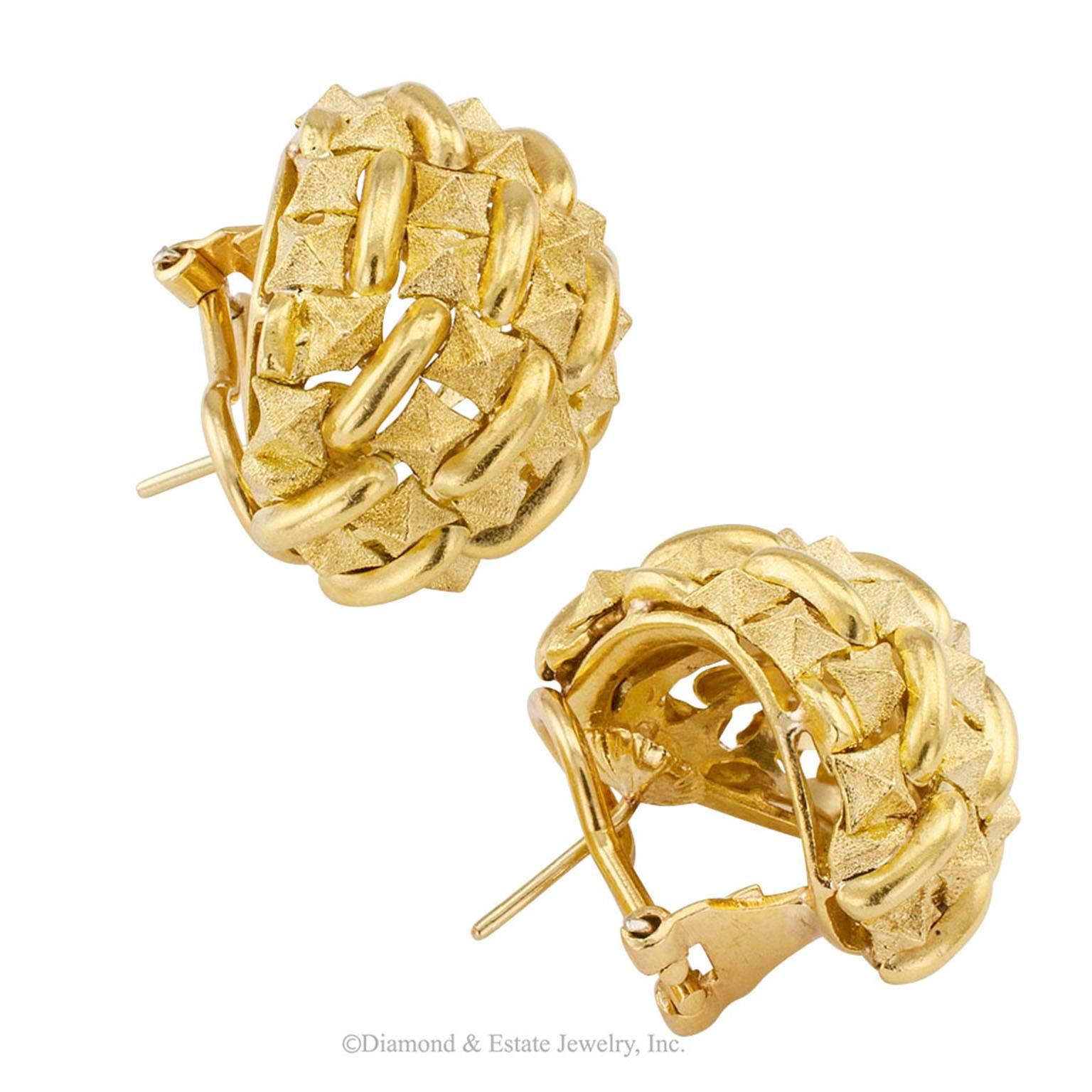 1970s Domed Earrings Textured Gold

Estate 1970s domed textured 18-karat gold earrings.  The matching designs feature a neatly arranged, tight pattern of geometric shapes comprishing twin square piramids finished in matt gold, between oblong