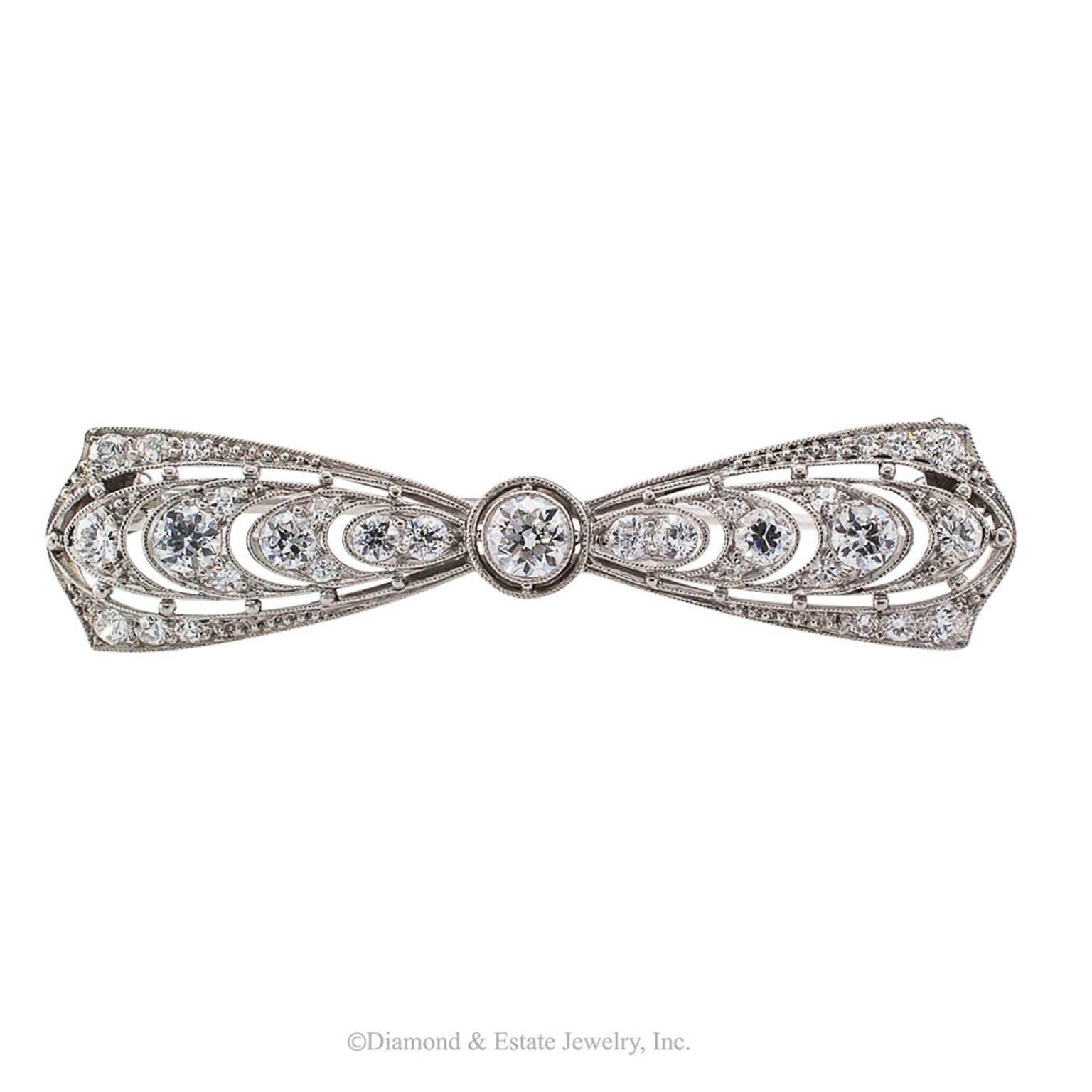 T B Starr Edwardian Diamond Platinum Bow Brooch

T B Starr Edwardian diamond and platinum bow brooch circa 1910.  Designed as a bow centering an old-cut diamond flanked by outwardly graduating similarly cut diamonds, on a platinum mounting that is a