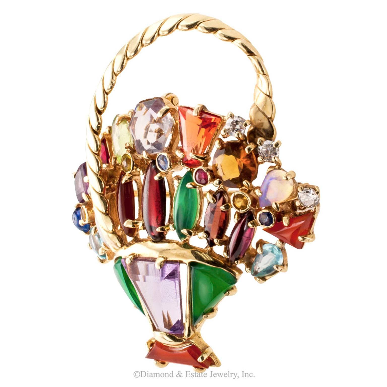 1950s Color Gemstone Diamond Gold Basket Brooch/Pendant

Mid-century multi color gemstone and 14-karat yellow gold basket brooch/pendant.  The design incorporates a wide range of gemstones to produce an effect resembling a basket of flowers. The