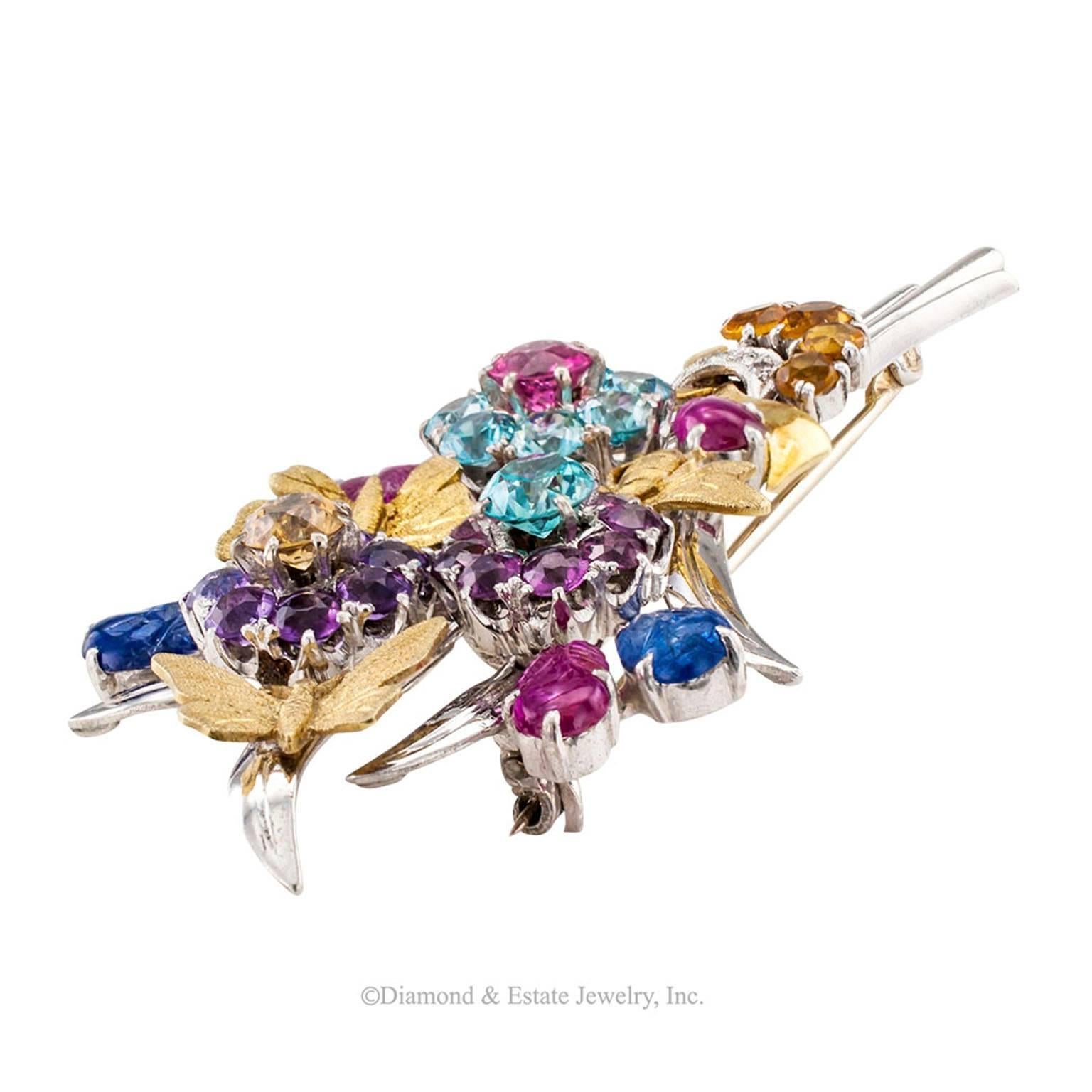 Retro 1940s Gemstone Gold Flower Bouquet Brooch

Retro gemstone flower bouquet and two-tone 14-karat gold brooch circa 1940.  Gathered with a ribbon of diamonds and a gold bow these fanciful and magnificent flowers are composed by amethyst,