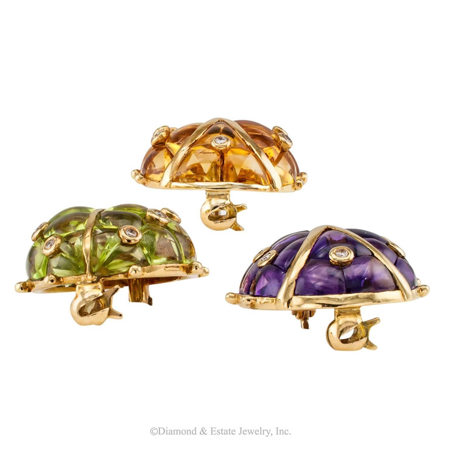 1970s Gem Set Ladybug Trio Gold Brooches 

1970s trio of gem-set ladybug brooches in 18-karat gold with amethyst citrine diamond peridot and ruby. These adorable ladybug brooches have wings set with vibrant color, precision-cut buff top amethyst,