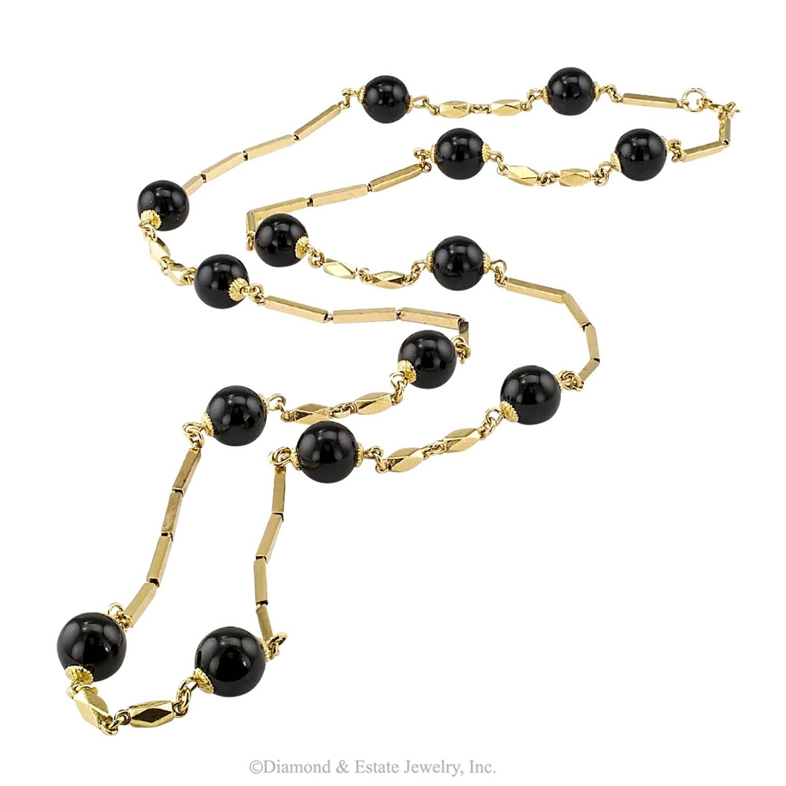 1960s Onyx Gold Chain Necklace

1960s onyx beads and 18 karat yellow gold links chain necklace.  A timeless design featuring slender baton gold links connected, at intervals, to round onyx beads separated by twin diamond-sided, elongated gold 