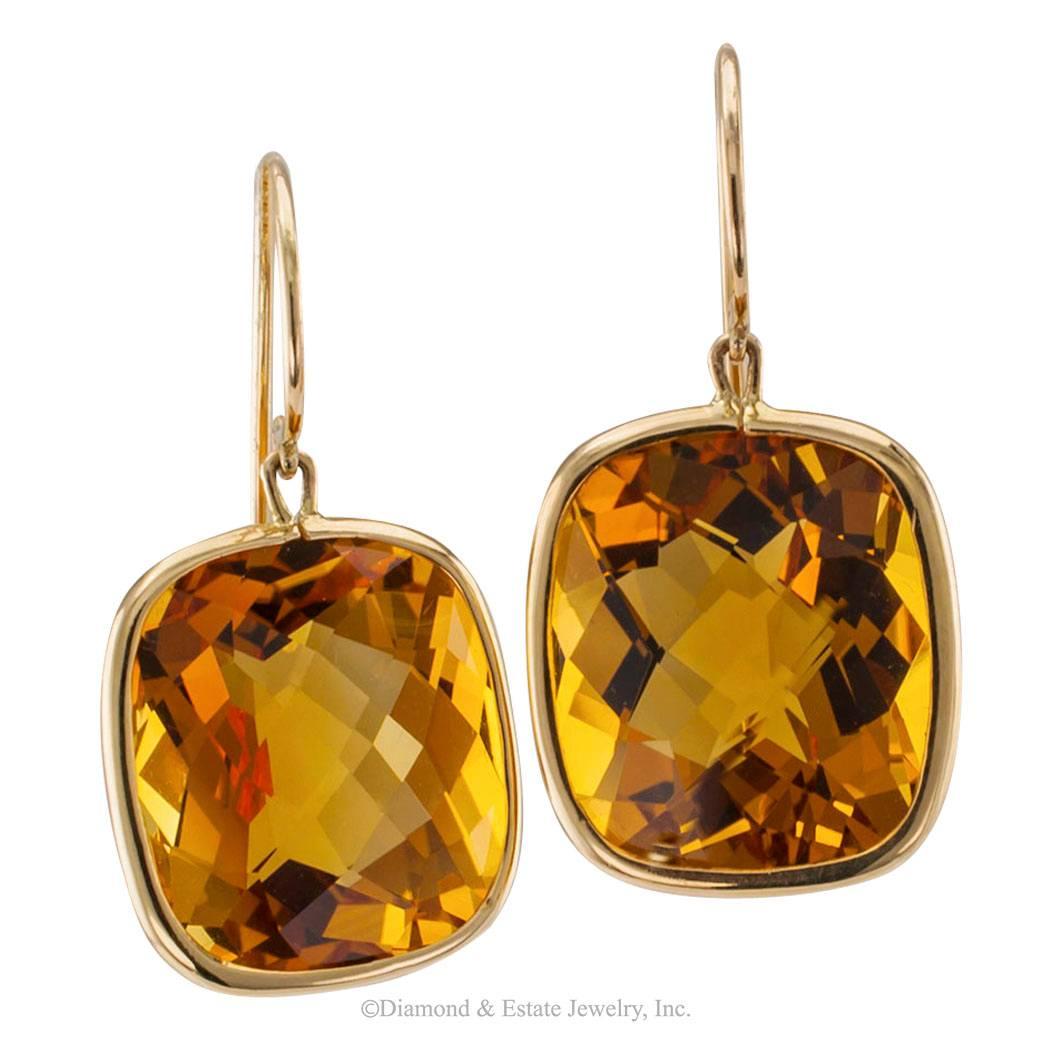 Rose Cut Citrine Gold Pendent Earrings

Pendent rose cut citrine and gold earrings.  The design features a pair of large, cushion-cut citrines with rose-cut faceting, radiating with the colors of sunshine and freshly harvested honey , together