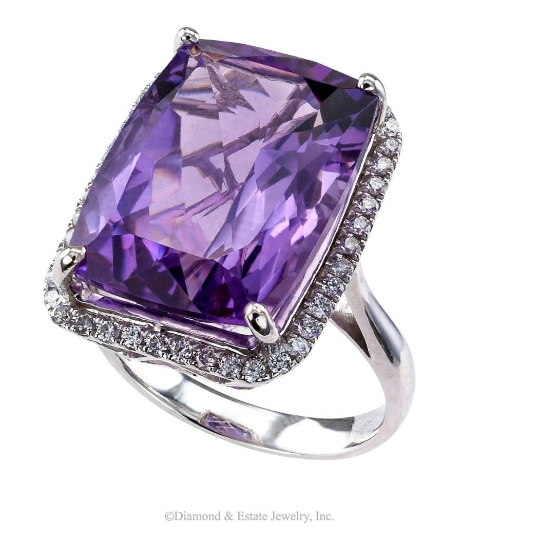 Amethyst Diamond Gold Cocktail Ring

Amethyst and diamond white gold cocktail ring circa 2000.  Showcasing a large modified cushion-cut amethyst weighing approximately 12.50 carats, framed by forty-four small round brilliant-cut diamonds totaling
