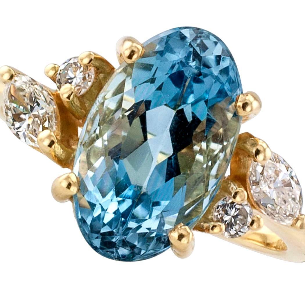 H Stern Aquamarine Diamond Gold Ring

H Stern aquamarine and diamond gold ring.  Centering upon an oval aquamarine weighing approximately 2.50 carats between asymmetrical shoulders set with marquise and round brilliant-cut diamonds totaling