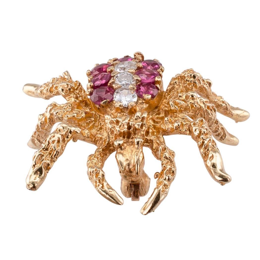 Spider Brooch 1970s Ruby Diamond Gold

Spider gold brooch circa 1970 set with rubies and diamonds.  A little spider brooch with its textured 14-karat gold legs outstretched, its abdomen set with a trio of round brilliant-cut diamonds totaling