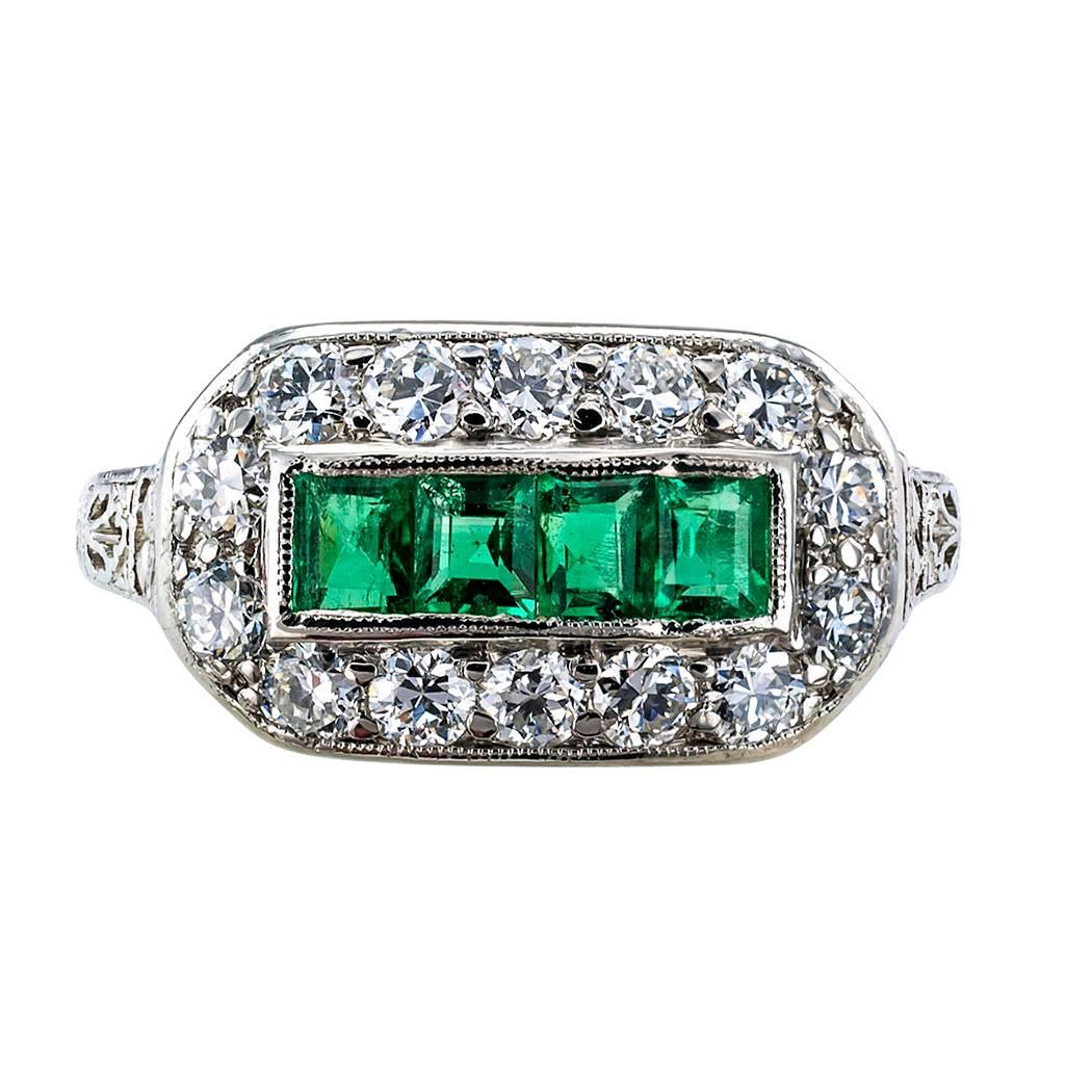 Art Deco 1925 Emerald Diamond Platinum Ring

Art Deco 1925 emerald and diamond platinum ring.  The design showcases four, very well matched, rectangular-shaped Colombian emeralds, framed by fourteen old European-cut diamonds totaling approximately