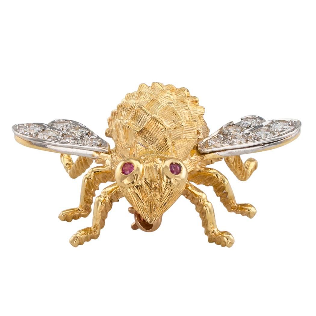 Rosenthal 1970s diamond ruby and gold honey bee brooch. Mounted in 18-karat gold, the wings set with round brilliant-cut diamonds totaling approximately 0.70 carat, approximately G color and VS clarity, ruby-set eyes to the body accentuated by a