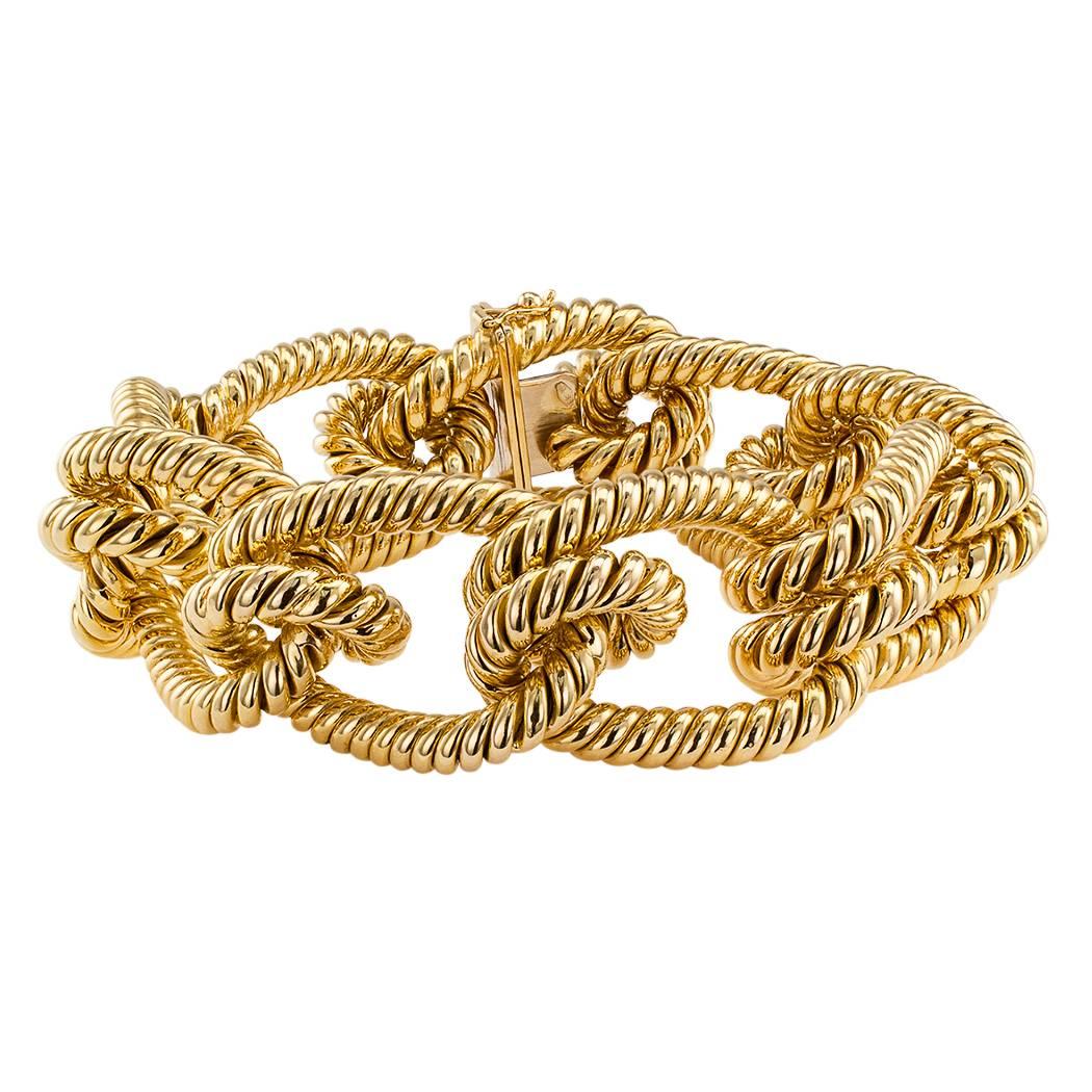 Gold knotted rope bracelet circa 1970. Designed as a bright 18-karat yellow gold rope tied in a series of large open knots, this is a chunky-gold-bracelet-lover's dream come true. Definitely makes a statement with its colossal size and unique