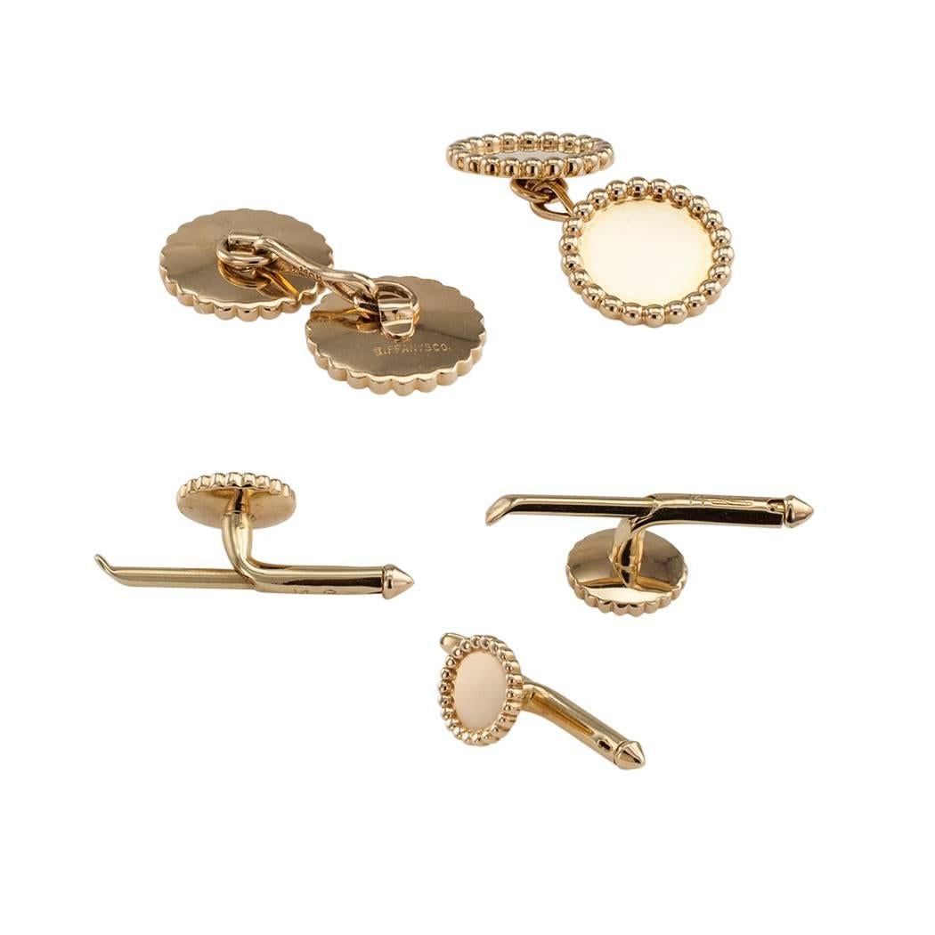 Tiffany & Co 1970s gold gentlemans dress set. Comprising a pair of double faced cuff links and three shirt studs, crafted in bright polished 14-karat yellow gold. Tiffany & Co a name synonymous with timeless styling, fine quality materials and