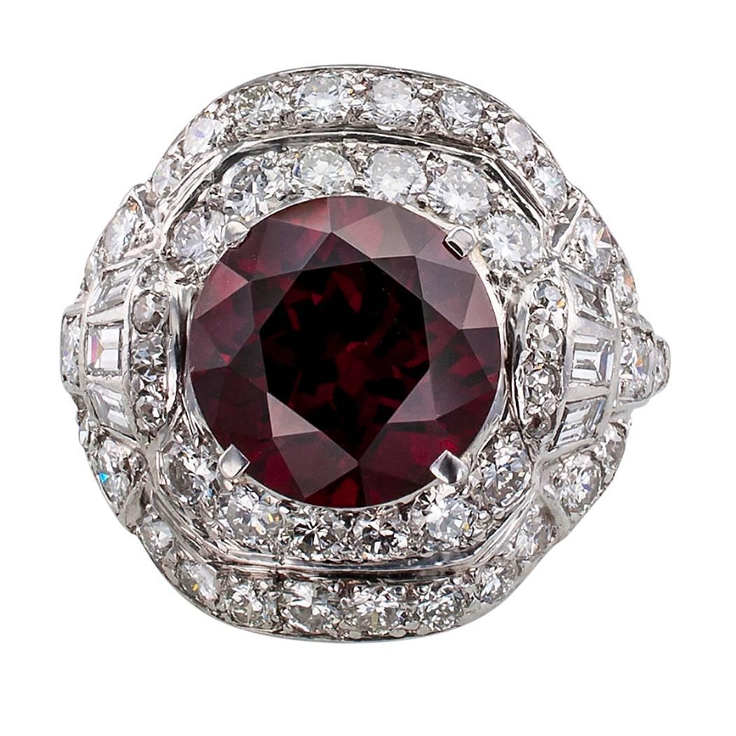 1930s garnet diamond and platinum domed ring. Centering a round garnet with beautiful red color, think ruby port wine, and weighing approximately 3.50 carats, on a slightly domed platinum mounting shimmering with fifty-three diamonds totaling