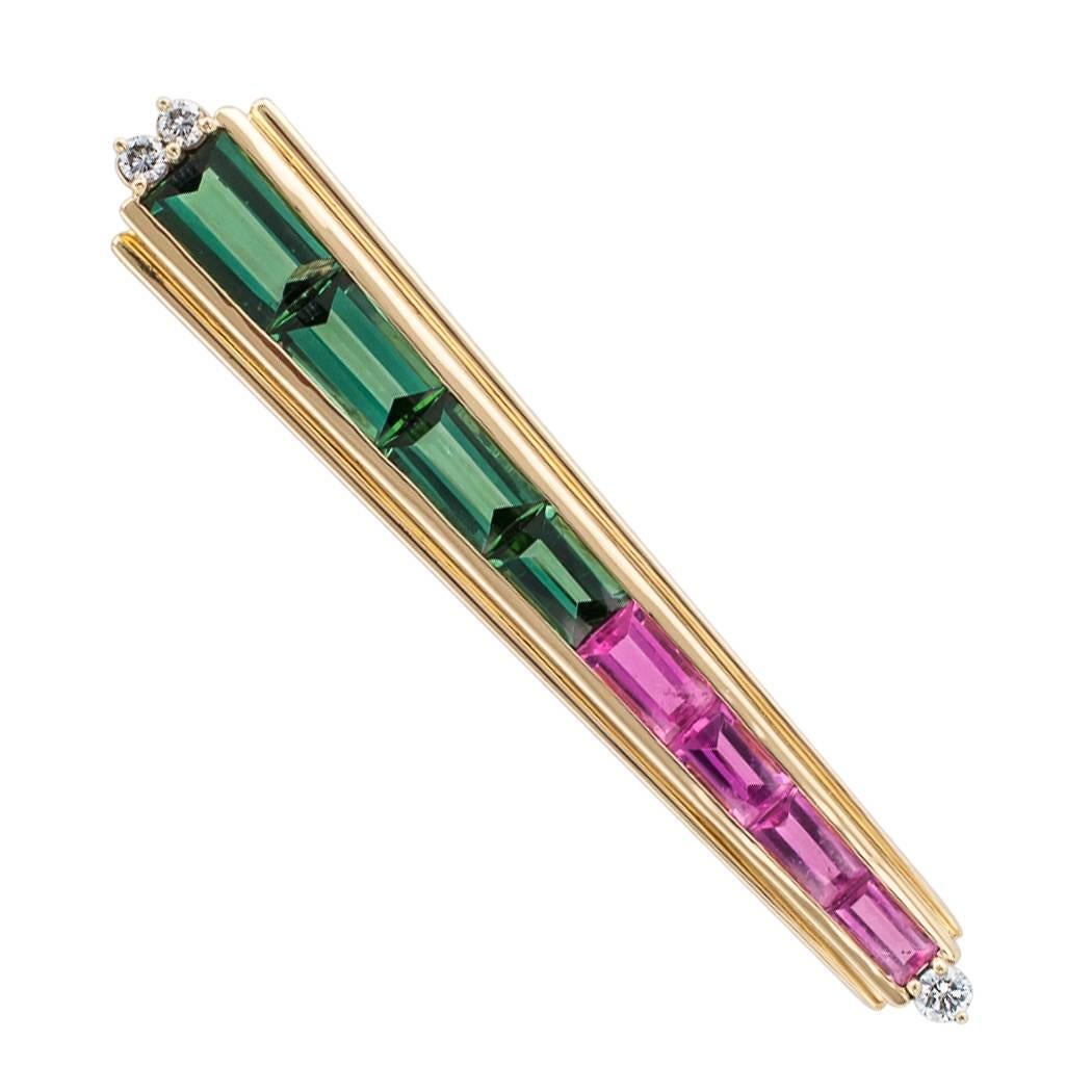 Musteiner 1980s 18 karat yellow gold brooch pendant set with diamonds pink and green tourmalines. The lozenge-shaped design features a graduated course comprising four green and an equal number of pink calibrated rectangular tourmalines together
