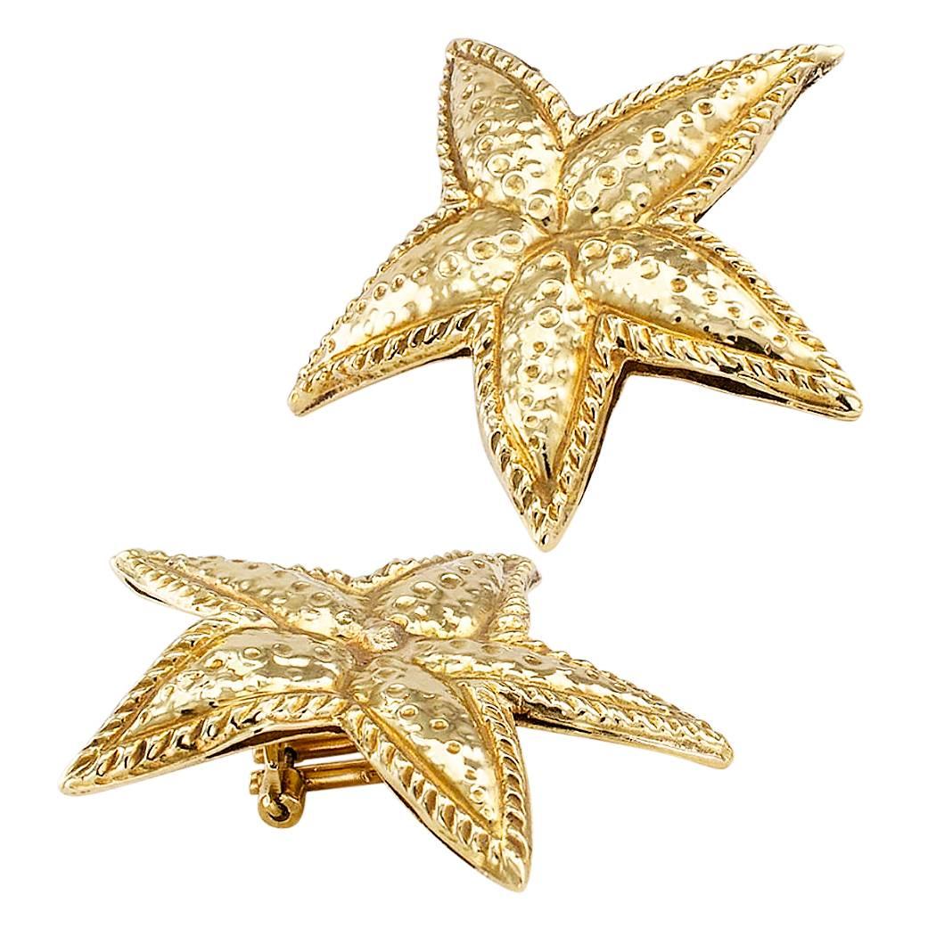 Starfish gold clip on earrings circa 1980. Sculpted and slightly free-form, these sea star ear clips are handcrafted in luminous 18-karat yellow gold with a bright polish, embellished with embossed textures mimicking the markings on starfish. It is