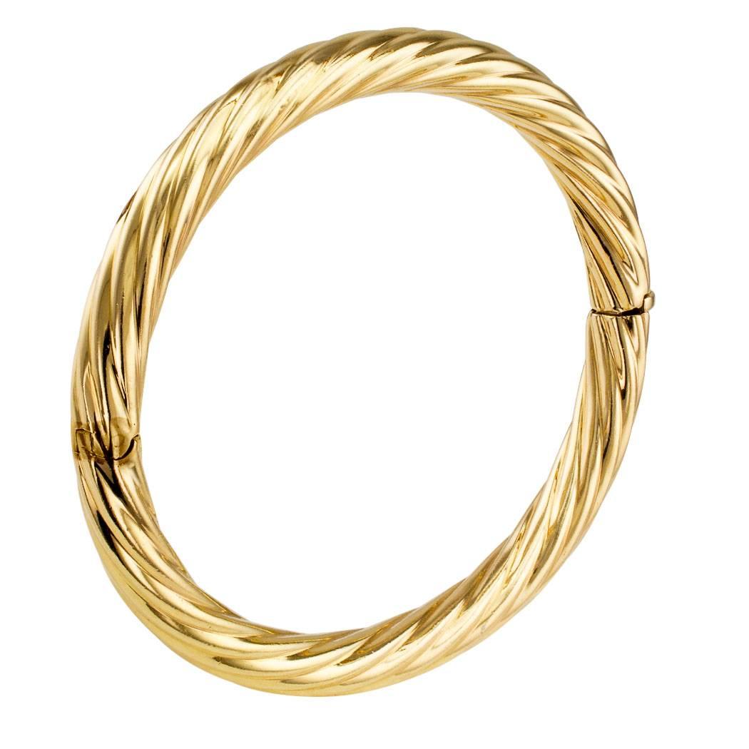 Tiffany & Co 1980s fluted gold bangle bracelet. Tiffany's classic gold bangle looks great when worn by itself or stacked with a bunch of other bangles for a chic eclectic look. Crafted in 14-karat yellow gold with maker's marks for Tiffany & Co