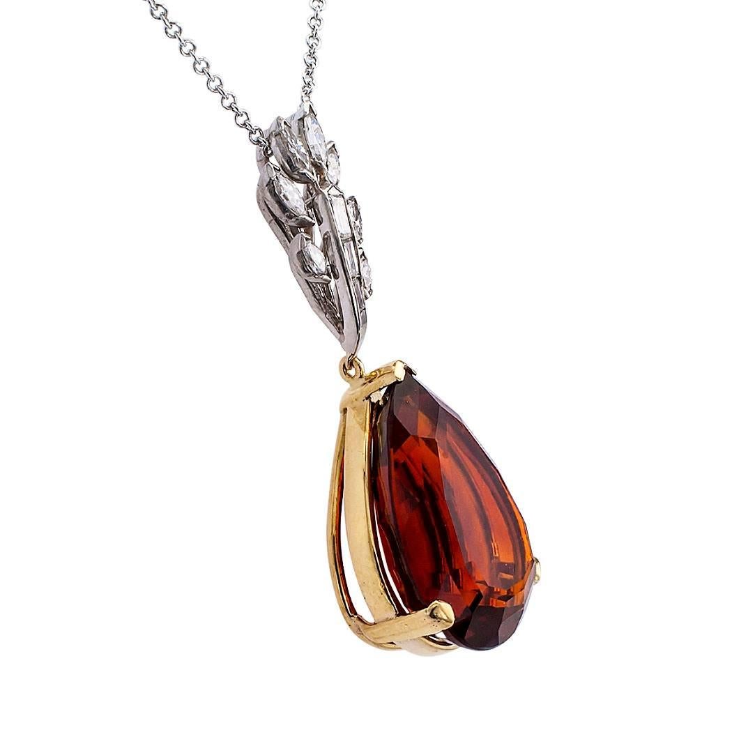 1960s Madeira citrine and diamond pendant mounted in gold and platinum. The articulated design showcases a magnificent teardrop-shaped Madeira citrine weighing approximately 21.00 carats, mounted in 18-karat yellow gold, connected to a diamond spray