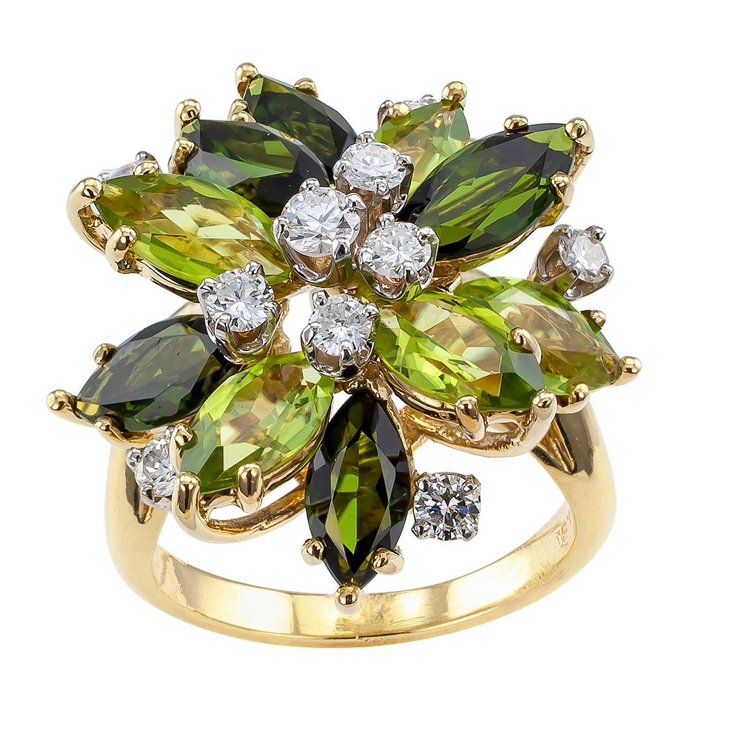 Peridot green tourmaline and diamond 18 karat gold cocktail ring circa 1970. The design features an arrangement of marquise-shaped green tourmalines alternating with similarly shaped peridots, dotted with ten smaller, round brilliant-cut diamonds