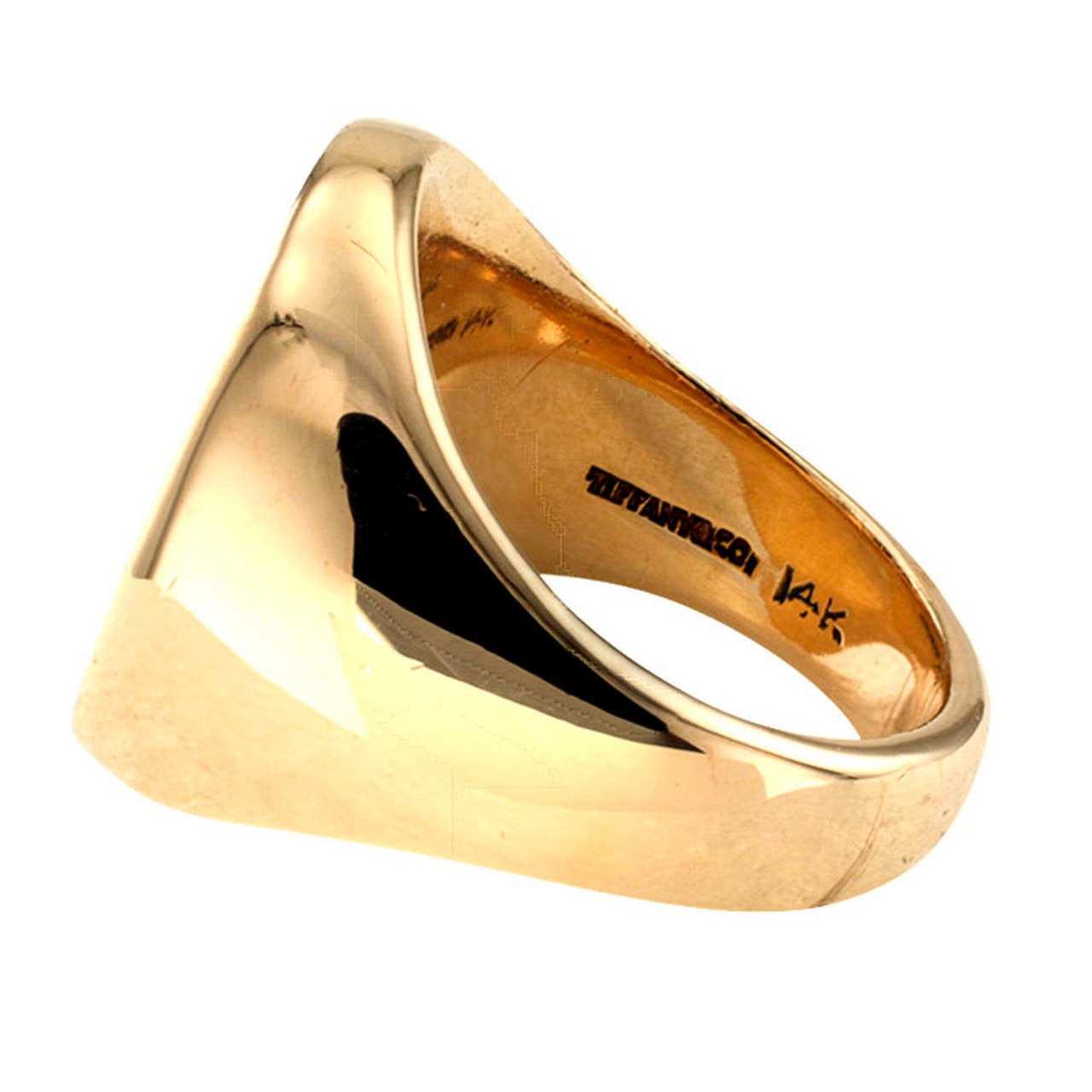 A classic signet ring by one of America's most famous and cherished jewelry manufactures, Tiffany & Co.  This particular one featuring an elegant intaglio crest in 14 karat yellow gold, ring size 6 1/2, 1 1/8 long vertical to the fingernail. This