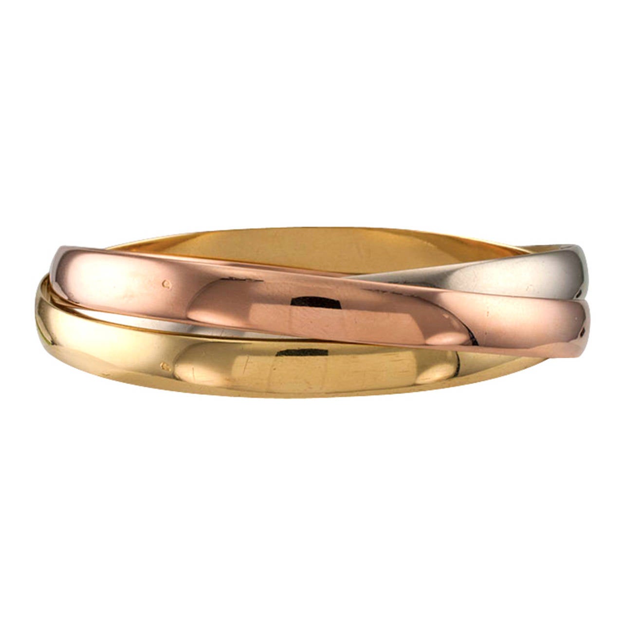 One of the definitions offered by the dictionary states that three things that form a unit are a trinity.  This sensuous and visually appealing bracelet comprises a trinity of 18 karat gold bands, pink, yellow and white.  They simply roll over the