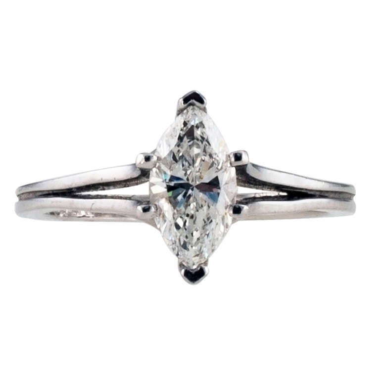 This modernistic designed ring showcases a very fine 0.86 carat marquise-cut diamond, D color, VS1 clarity, accompanied by a report from EGL-USA. The diamond is set between six prongs originating from the split shank and gallery, mounted in