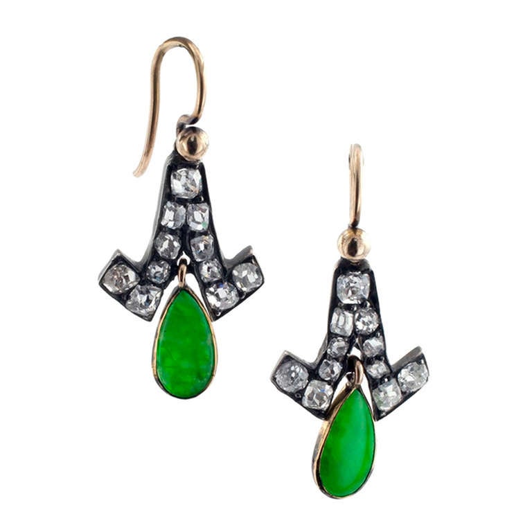 The articulated tulip-shaped motifs accented with old mine-cut diamonds totaling approximately 1.25 carats, each suspending a teardrop shaped (very rich green) natural color jade.   Approximately 1