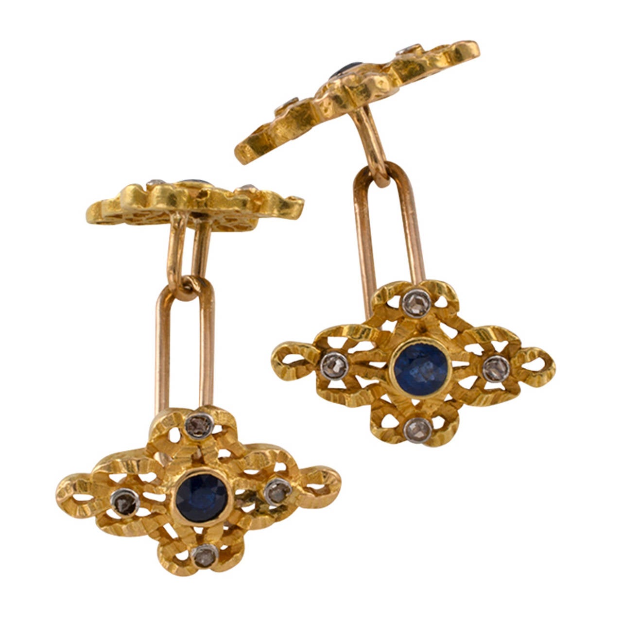 Art Nouveau Sapphire And Diamond Cuff Links

Unusual shape, these articulated, double-sided matching designs set with round sapphires and rose-cut diamonds are very striking.  Four sapphires and sixteen rose-cut diamonds, mounted in 18 karat gold,