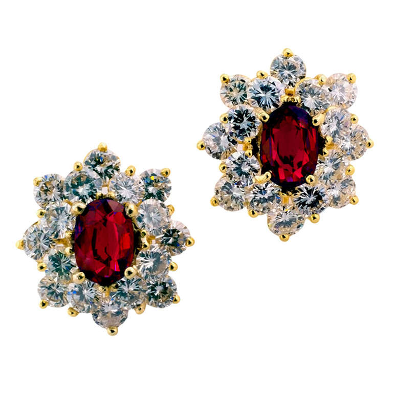 An easy pair of earrings to wear. With an elegant and timeless design, featuring a pair of bright oval rubies together weighing approximately 2.00 carats, framed by round brilliant-cut diamonds totaling approximately 4.50 carats (approximately