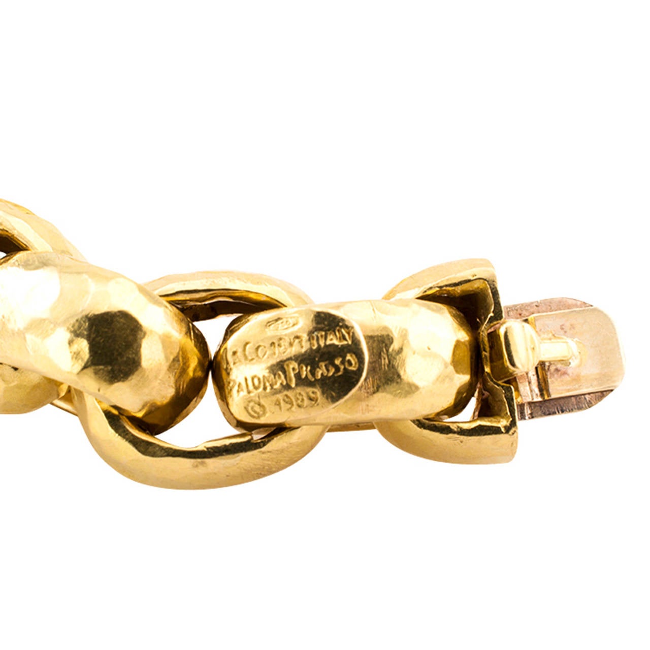 Tiffany & Co. Paloma Picasso Gold Link Bracelet

It is very easy to fall in love with the chunkiness of this bracelet, the genuine beauty and simplicity of Paloma Picasso's design.  The soft color of the gold and the hammer strike pattern that
