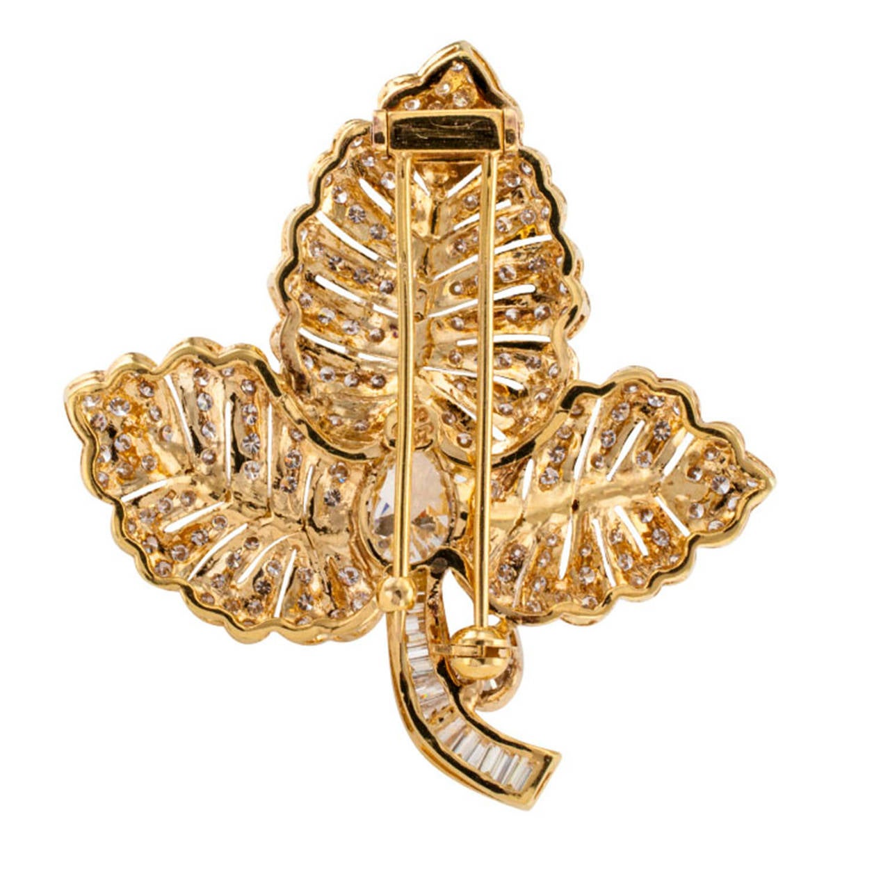 Diamond Intensive Leaf Brooch Circa 1980

This is an eye-catching design depicting a three part leaf that is seemingly covered with a heavy dew of shimmering diamonds  Joined at the center by a large teardrop-shaped diamond, rising from a stem