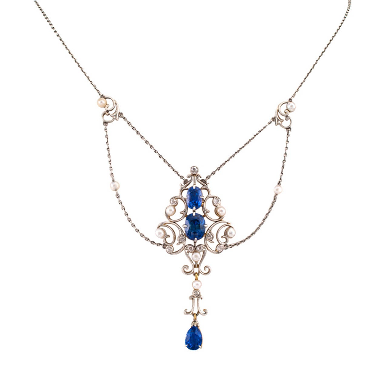 Edwardian Pearl Sapphire Diamond  Necklace

This lovely festooned design highlights three fine sapphires displaying a very appealing shade of blue, together weighing approximately 5.50 carats, accompanied by ten small diamonds totaling