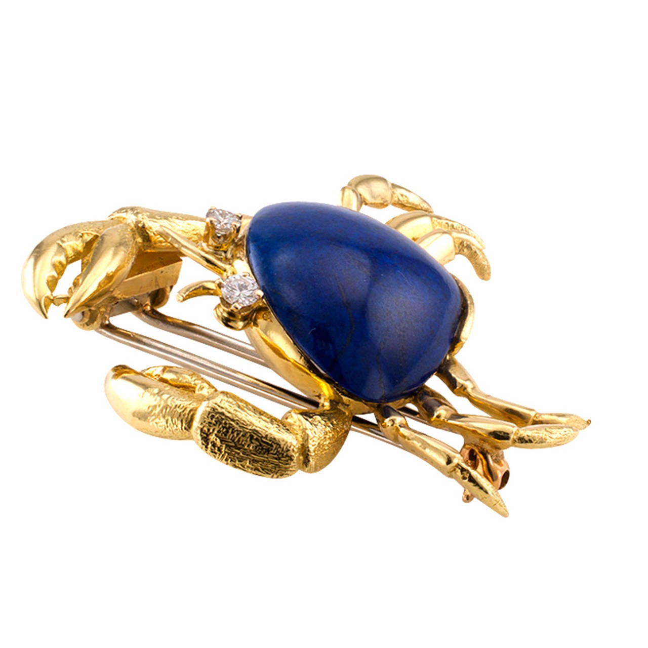 Tiffany & Co. Lapis Lazuli and Diamond Crab Brooch

Circa 1970, this 18 karat gold clip/brooch designed as a crab, its shell made of an incredible vibrant blue lapis stone along with glowing diamond eyes, by Tiffany & Co., approximately 1