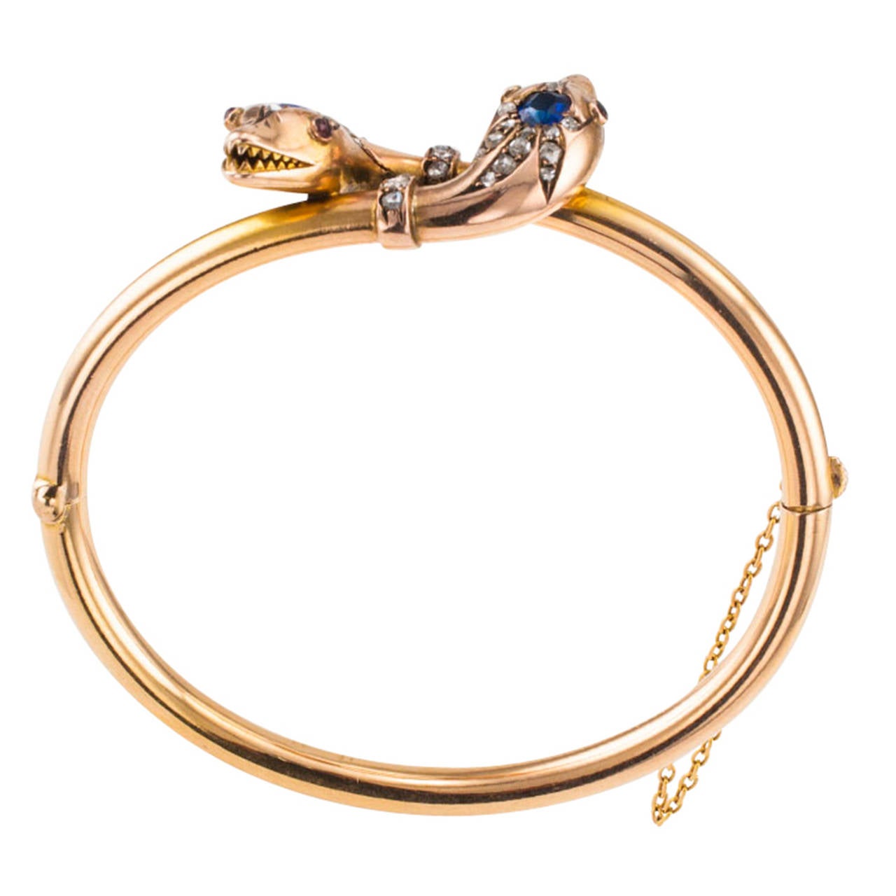 Bejeweled 15 Karat Gold Victorian Double Snake Bangle

Sensuous and beguiling snakes, sleek and mystifying, this heirloom antique bangle is free of damage or defects.  Decorated at the top with a pair of seductive snake heads, each crowned with a